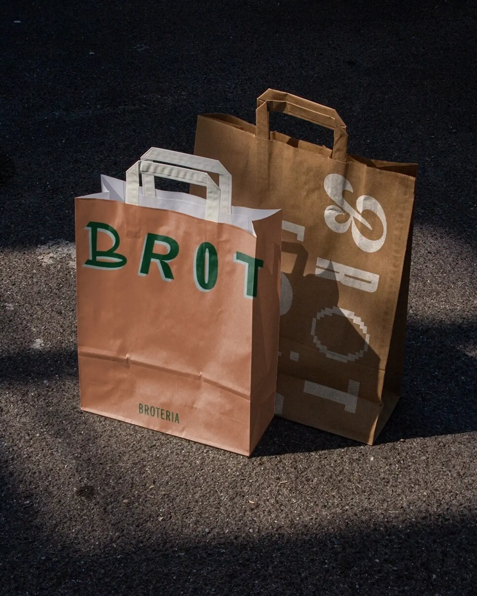 Orange Broteria pastry boxes with abstract white bread and loaf symbols