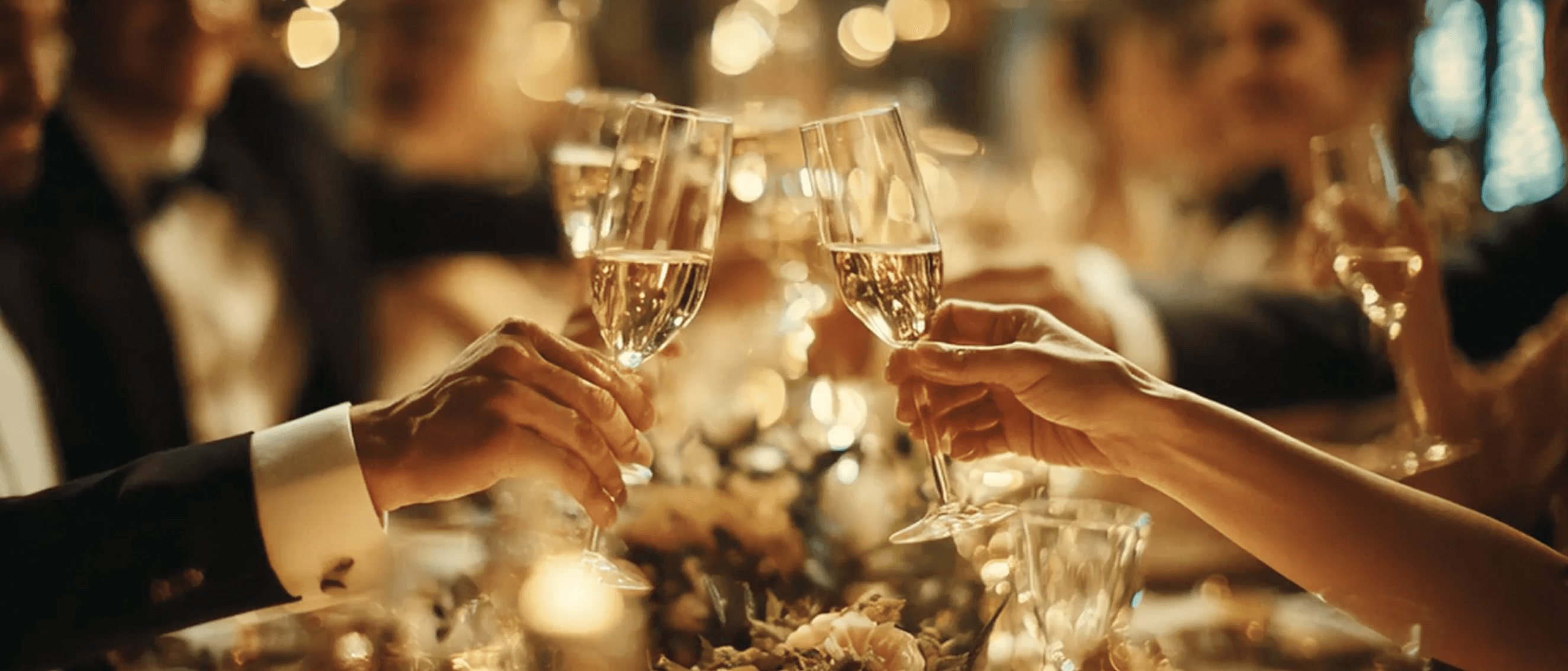 A warm close-up of people raising glasses for a toast, symbolizing celebration, togetherness, and joy.  