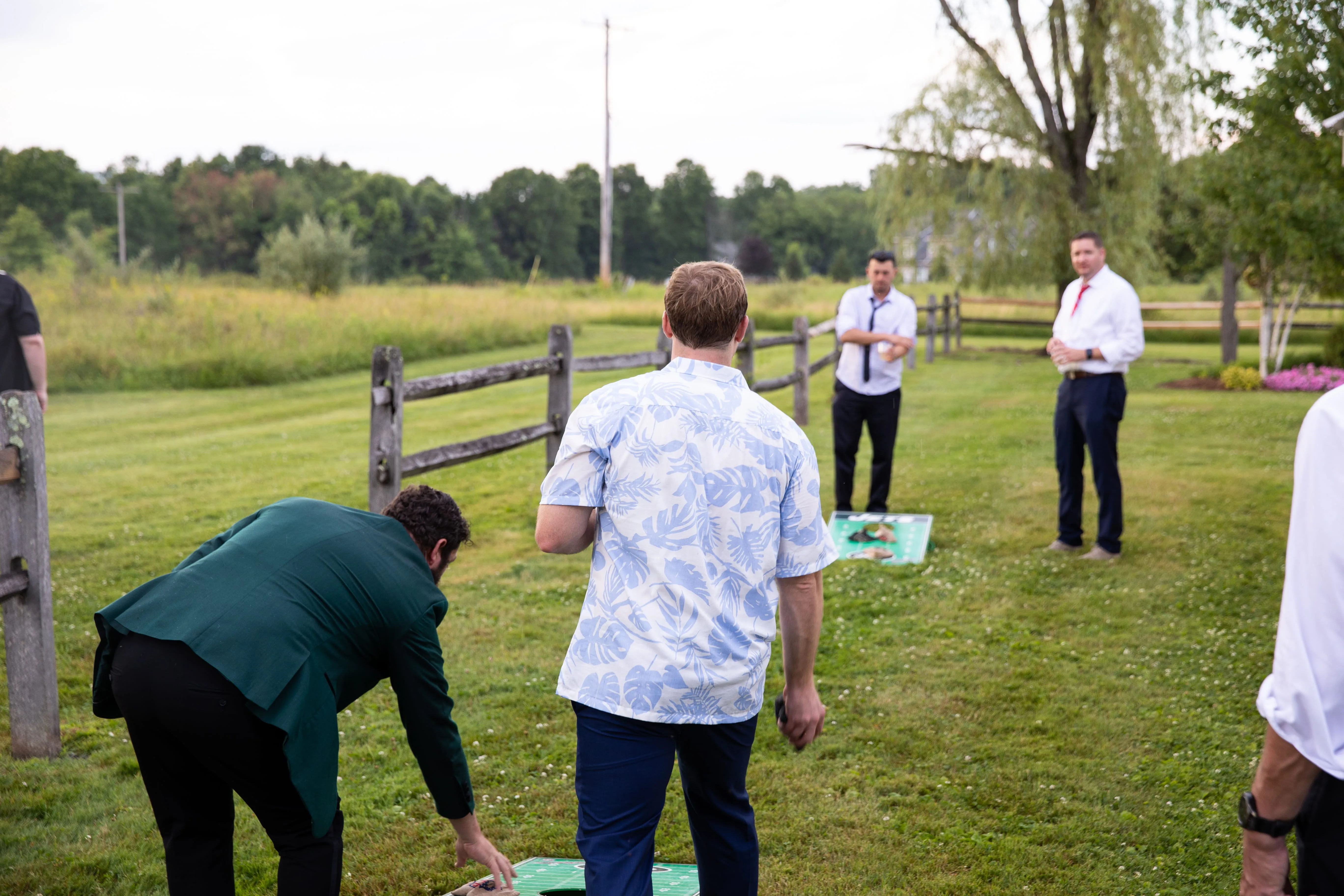 Wedding guests playing outdoor lawn games during reception