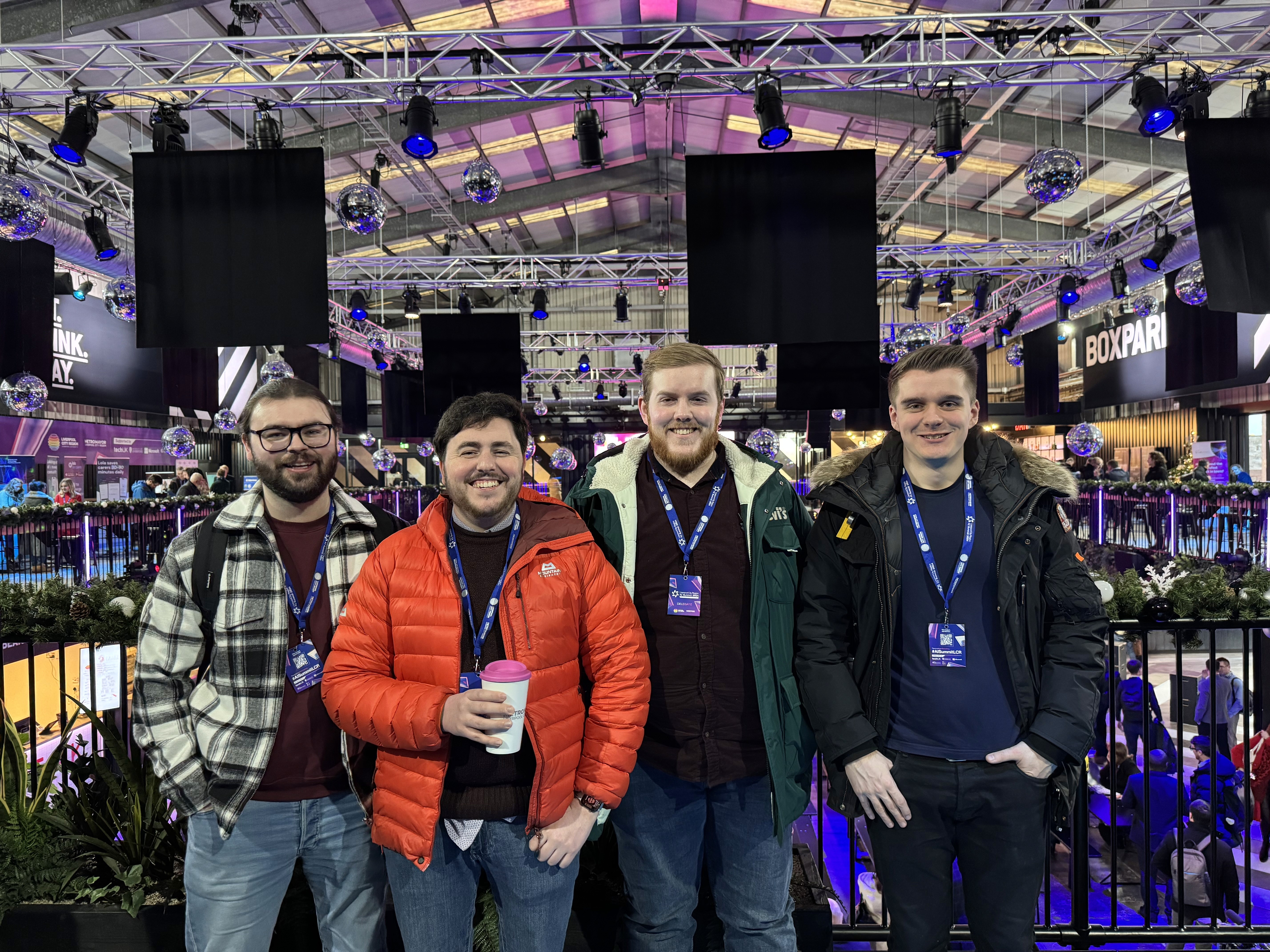 The Harker team (left to right: Tom, James, Zack and Matt) in a conference venue.