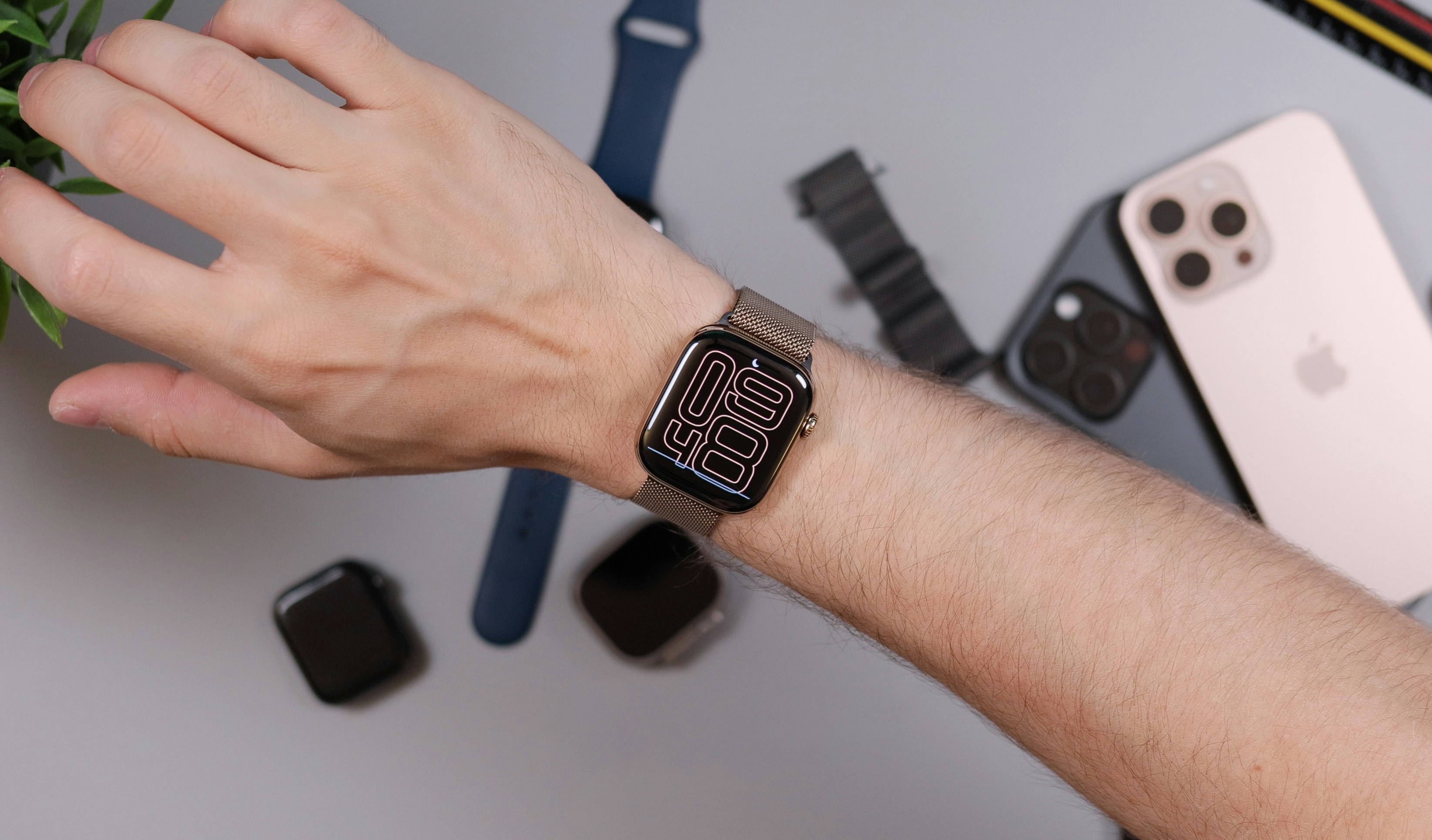 Apple Watch with a stainless steel Milanese mesh band worn on the wrist