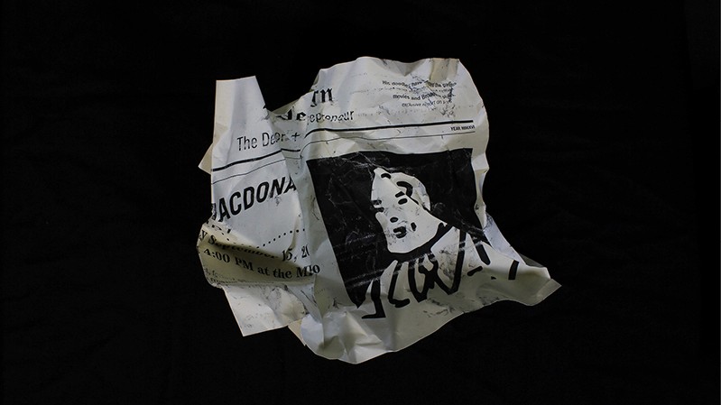 a tossed piece of paper with the Ross Macdonald event details