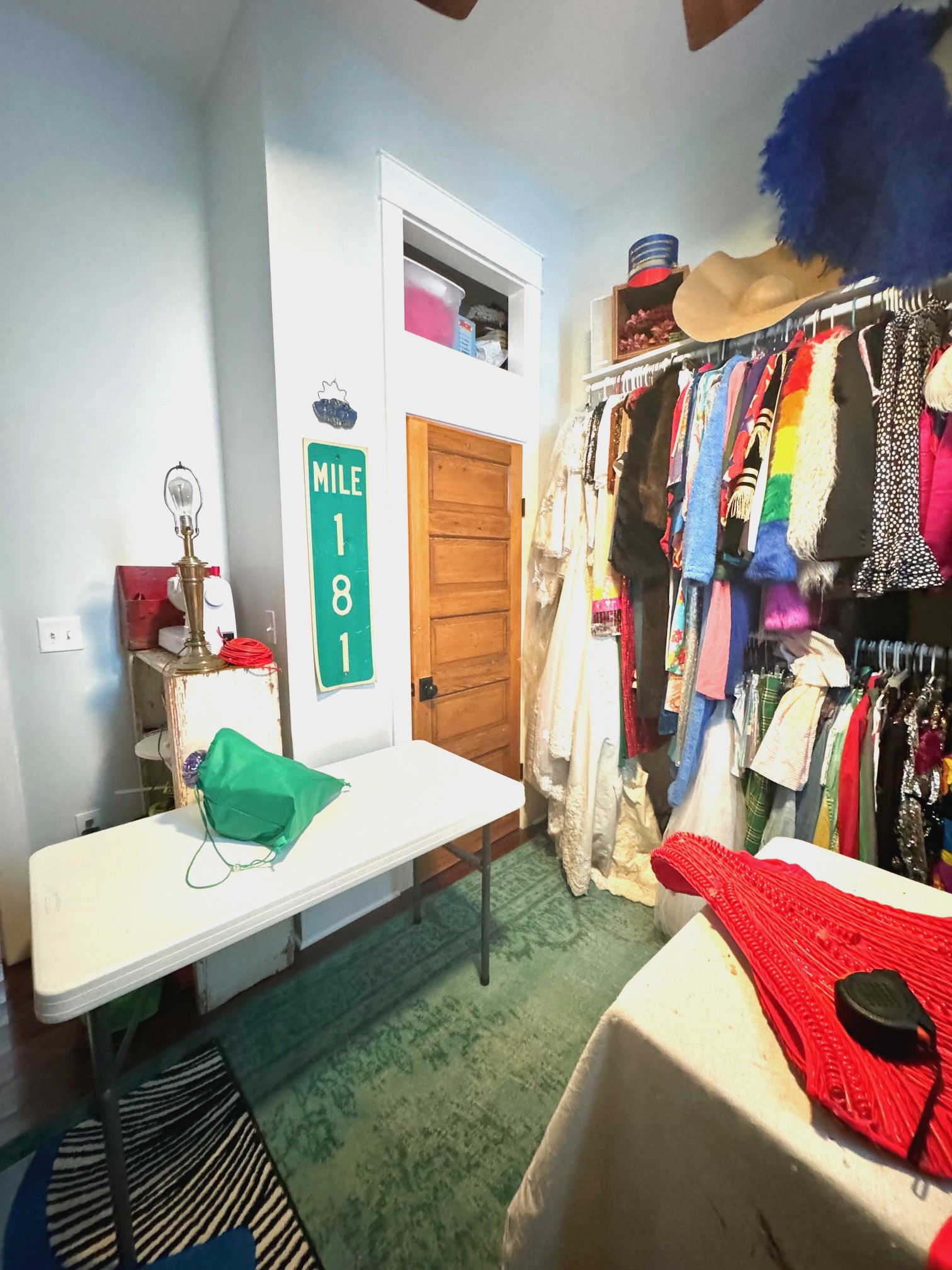 colorful costume room with lots of rugs and costumes and headpieces