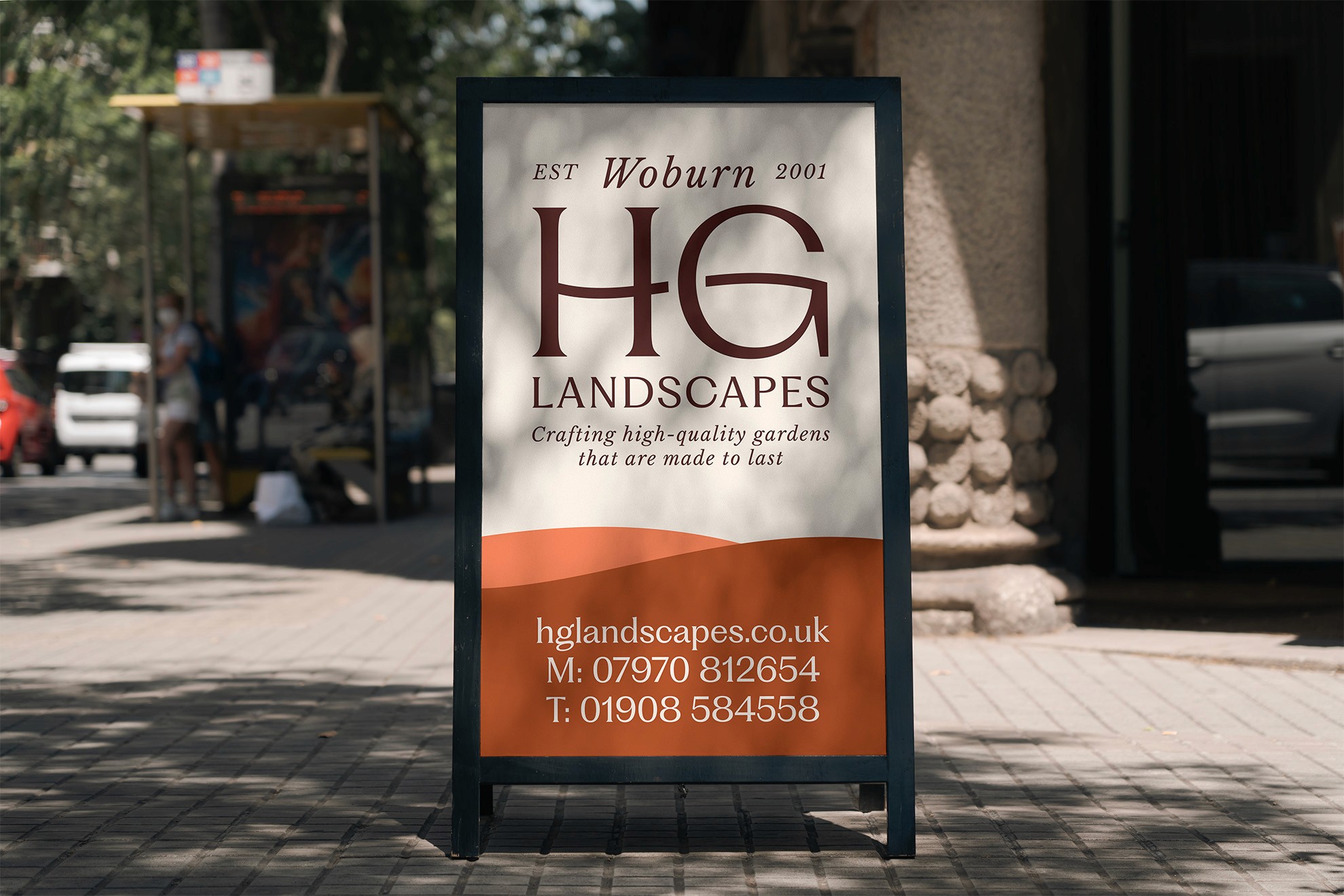 A sidewalk sign outside a store displaying the logo and promotional text for a business.