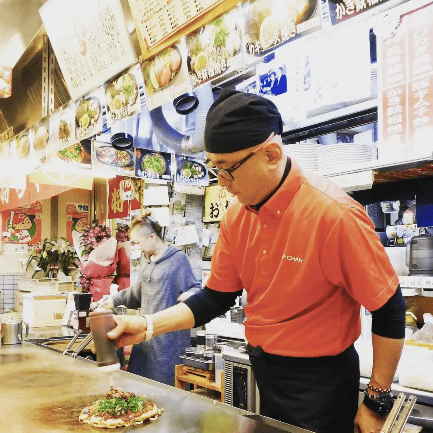 Chef making Okonomyaki in Hiroshima, Japan.