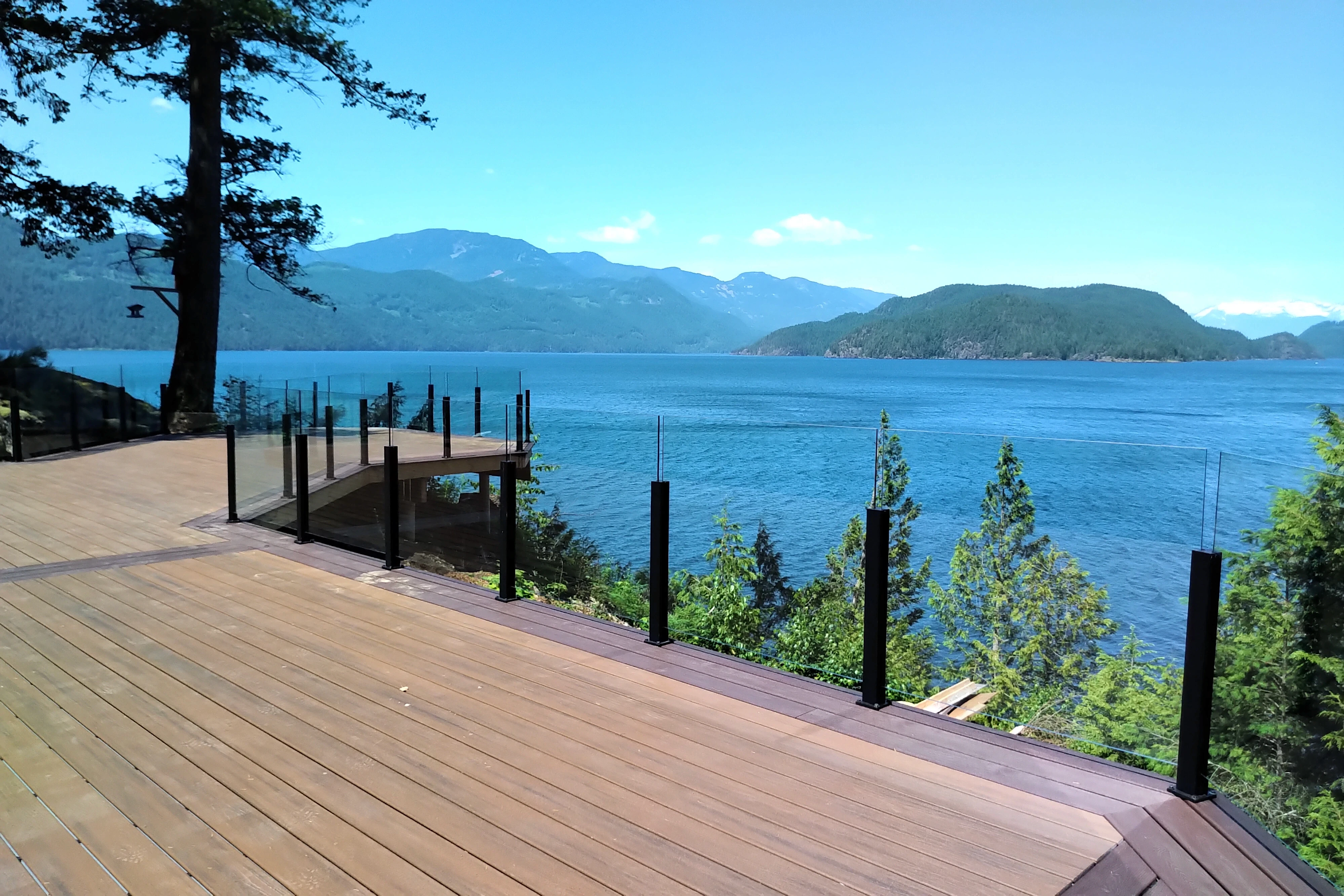 Frameless glass railing installed on a Nanaimo BC deck overlooking the harbour and Vancouver Island coastline.