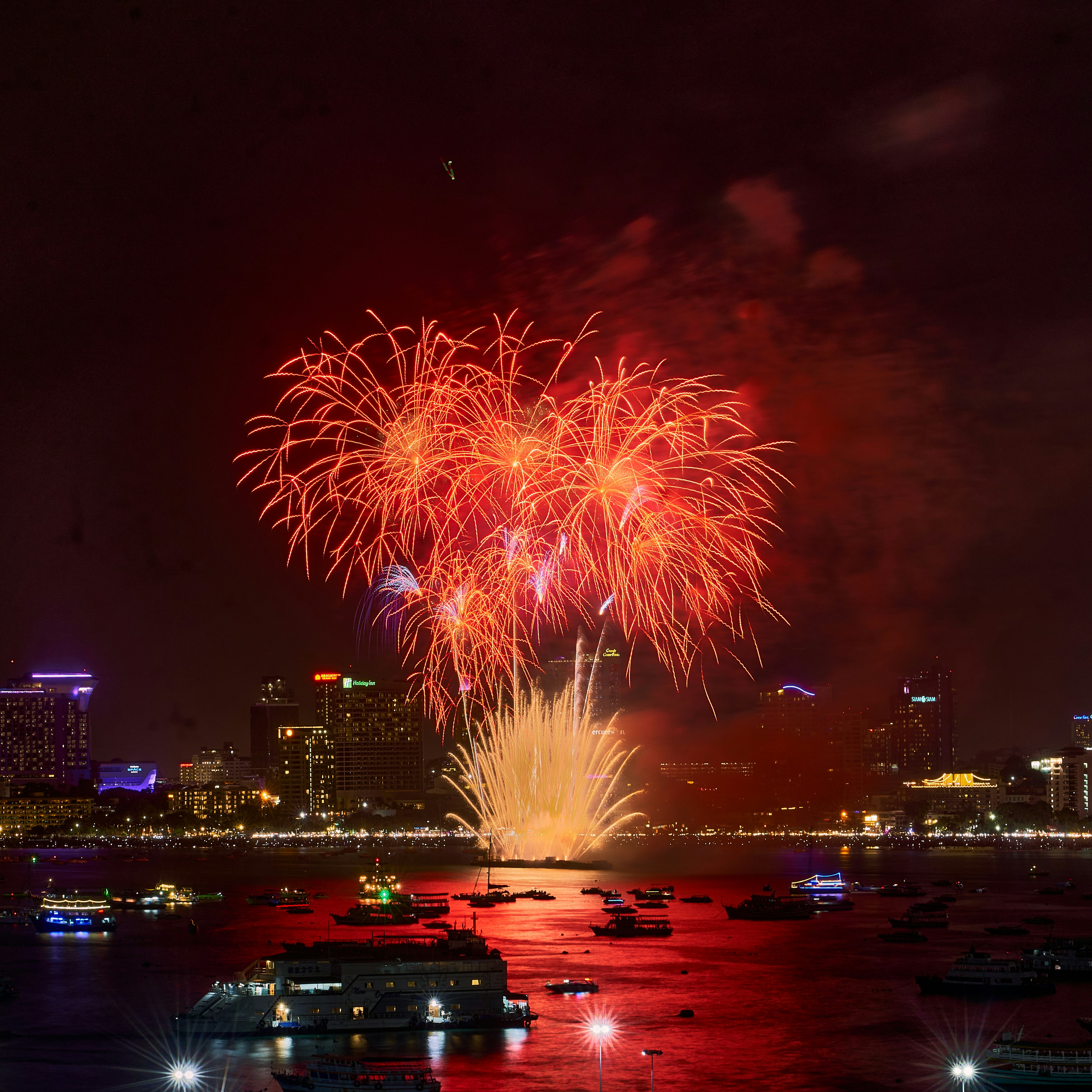 a fireworks display over a city at night