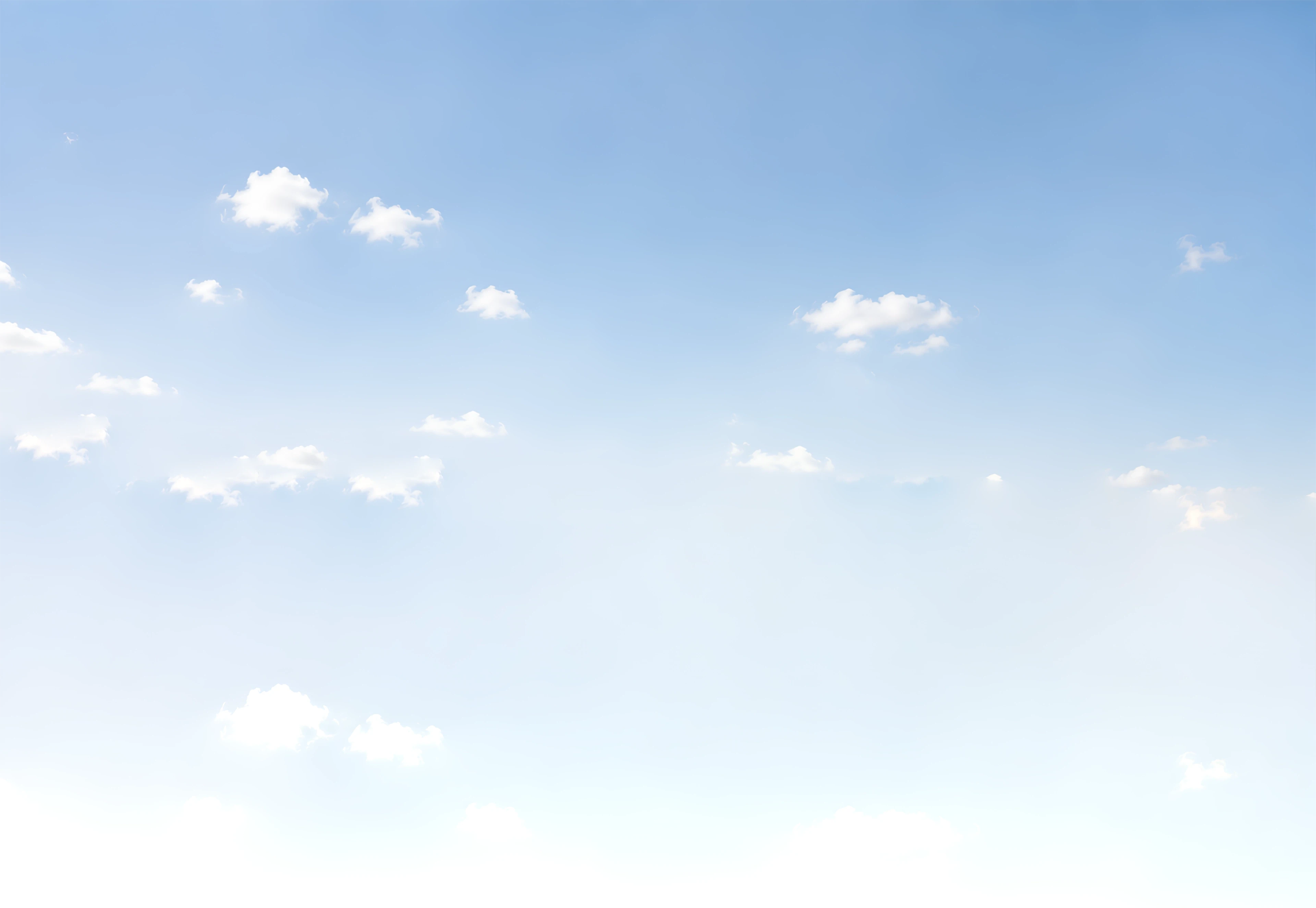 Soft blue sky scattered with light white clouds