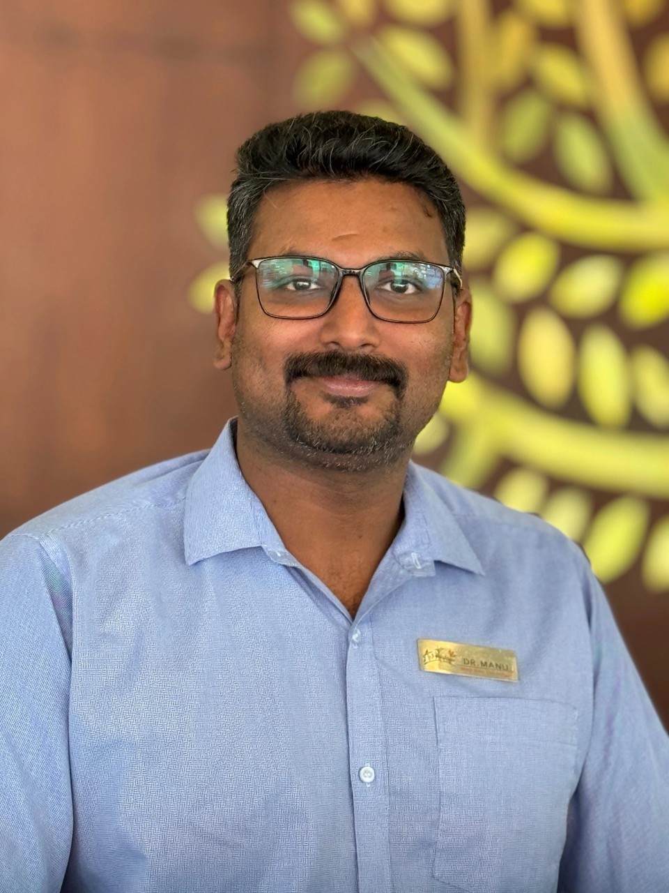 Dr. Manu Murali, Physician & Resident Medical Officer (RMO) at Au Revoir Resort, dedicated to holistic Ayurvedic wellness and healthcare