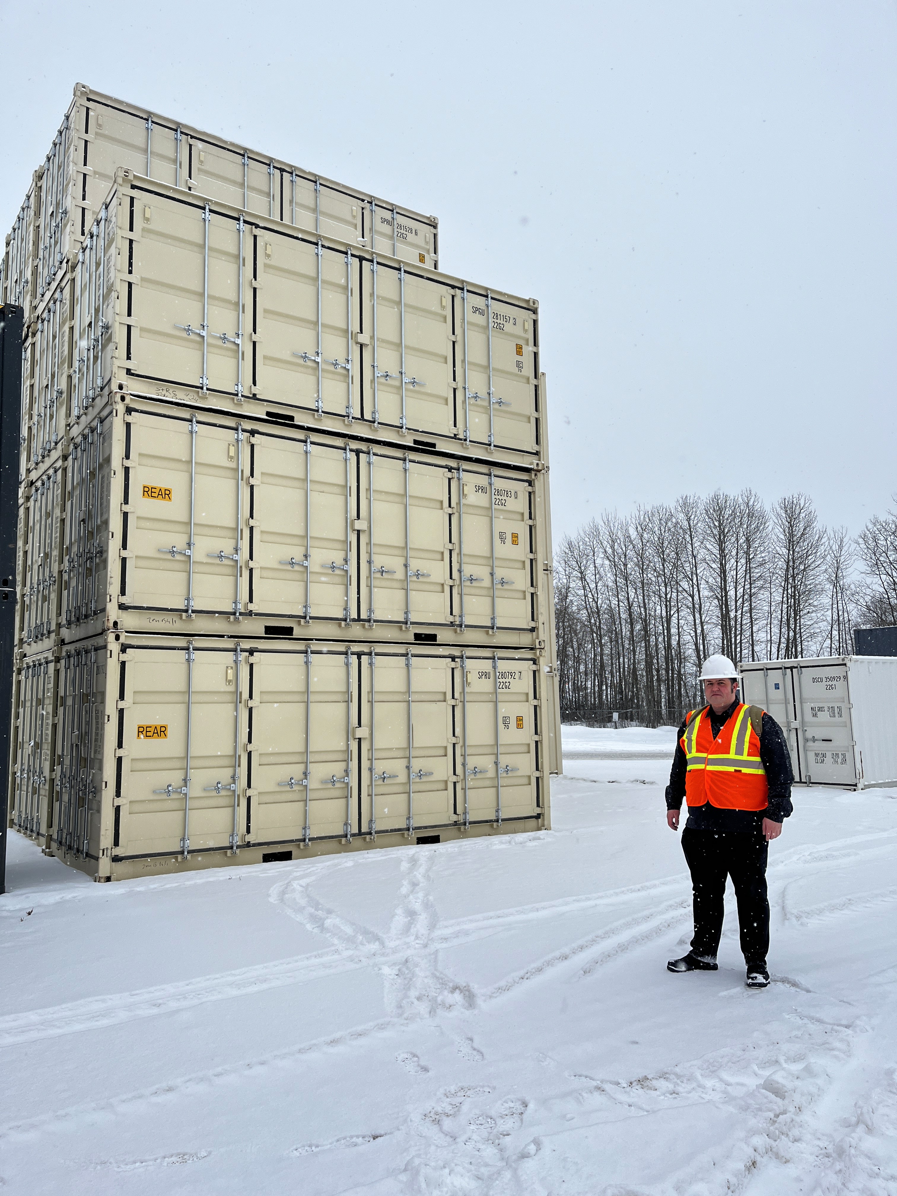 Stack of 20' New Open Side Beige containers and StoreCan's manager