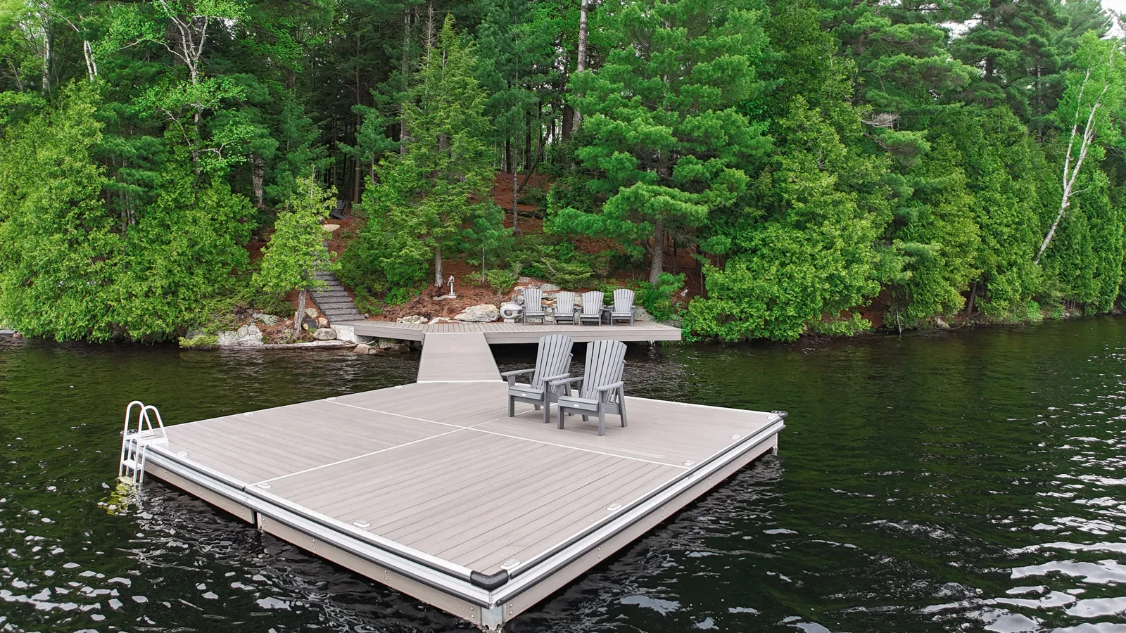 Large square shaped dock, decked with wood alternative planking. pinned directly to bedrock using dock-on-a-rock system.