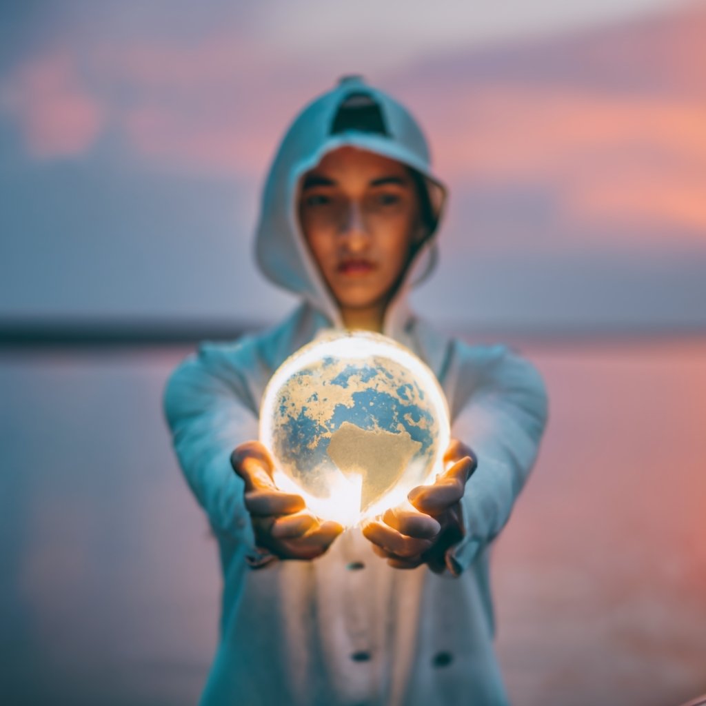 Individual holding a glowing globe highlighting North America, representing global talents aiming for the EB1A visa.