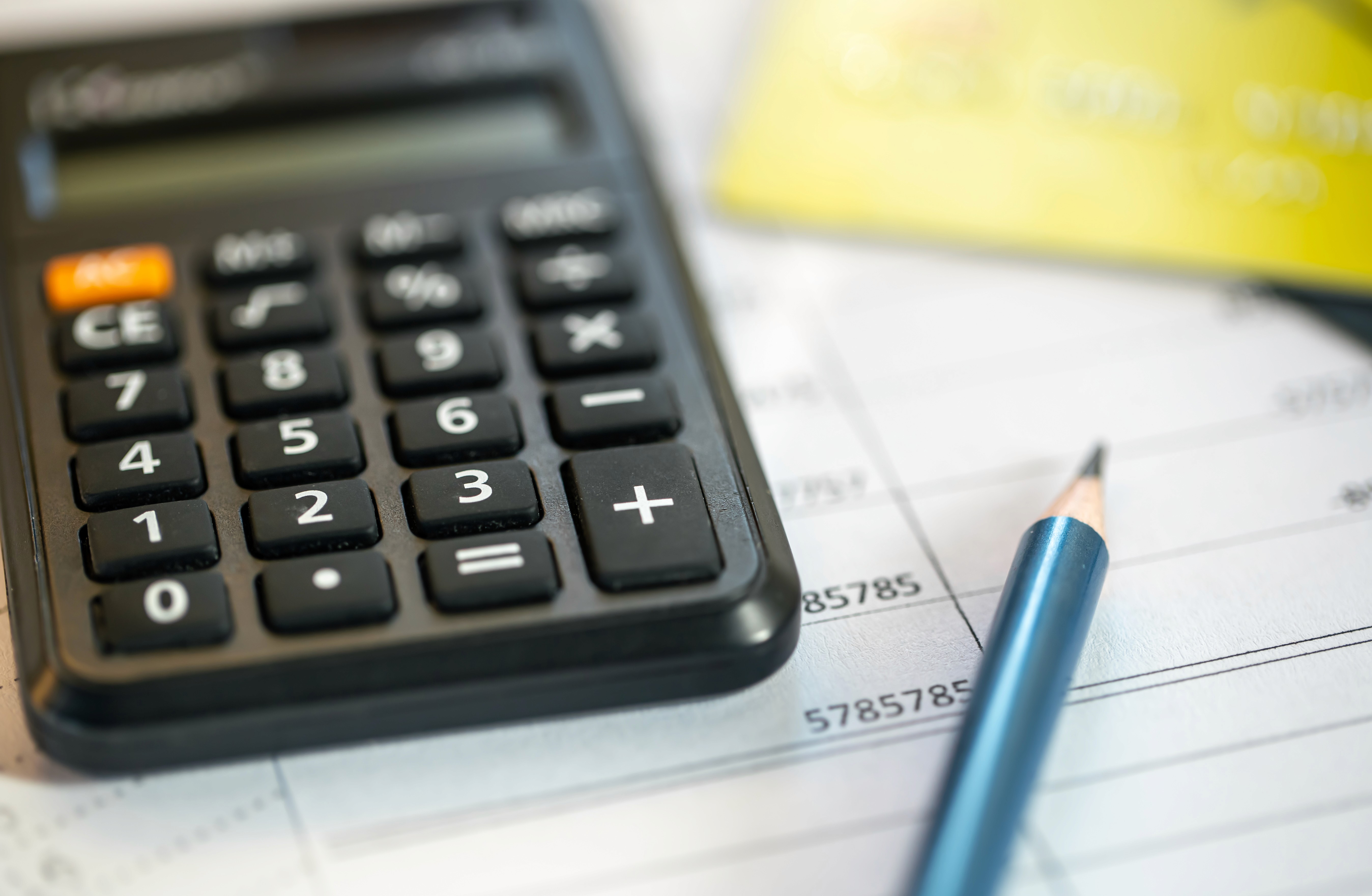 A price tag on a desk with a laptop and tablet