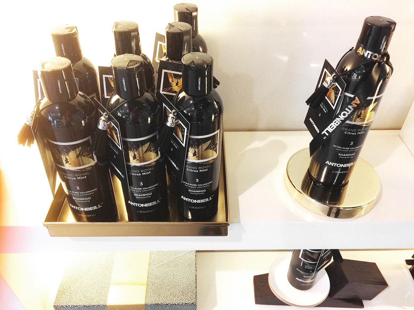 an image of a black and metallic gold hair care product with a premium finish