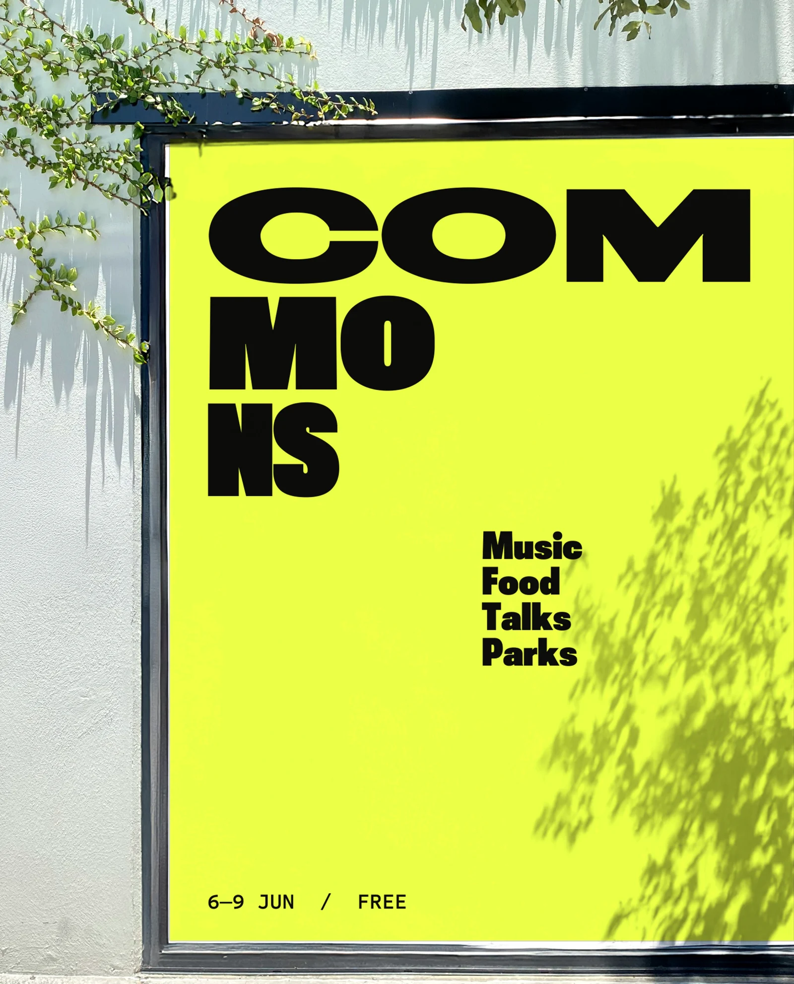 Yellow Commons festival poster on a white wall