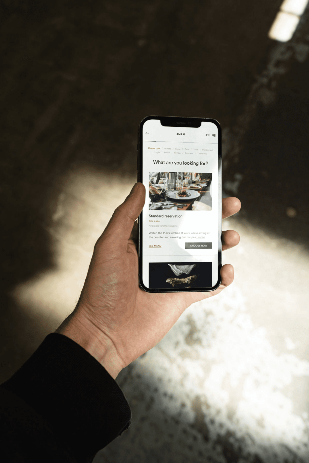 person holding iphone restaurant booking app