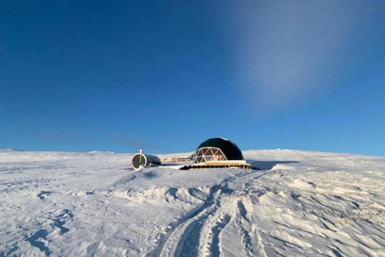 sunloungers fronting buildings near mountain