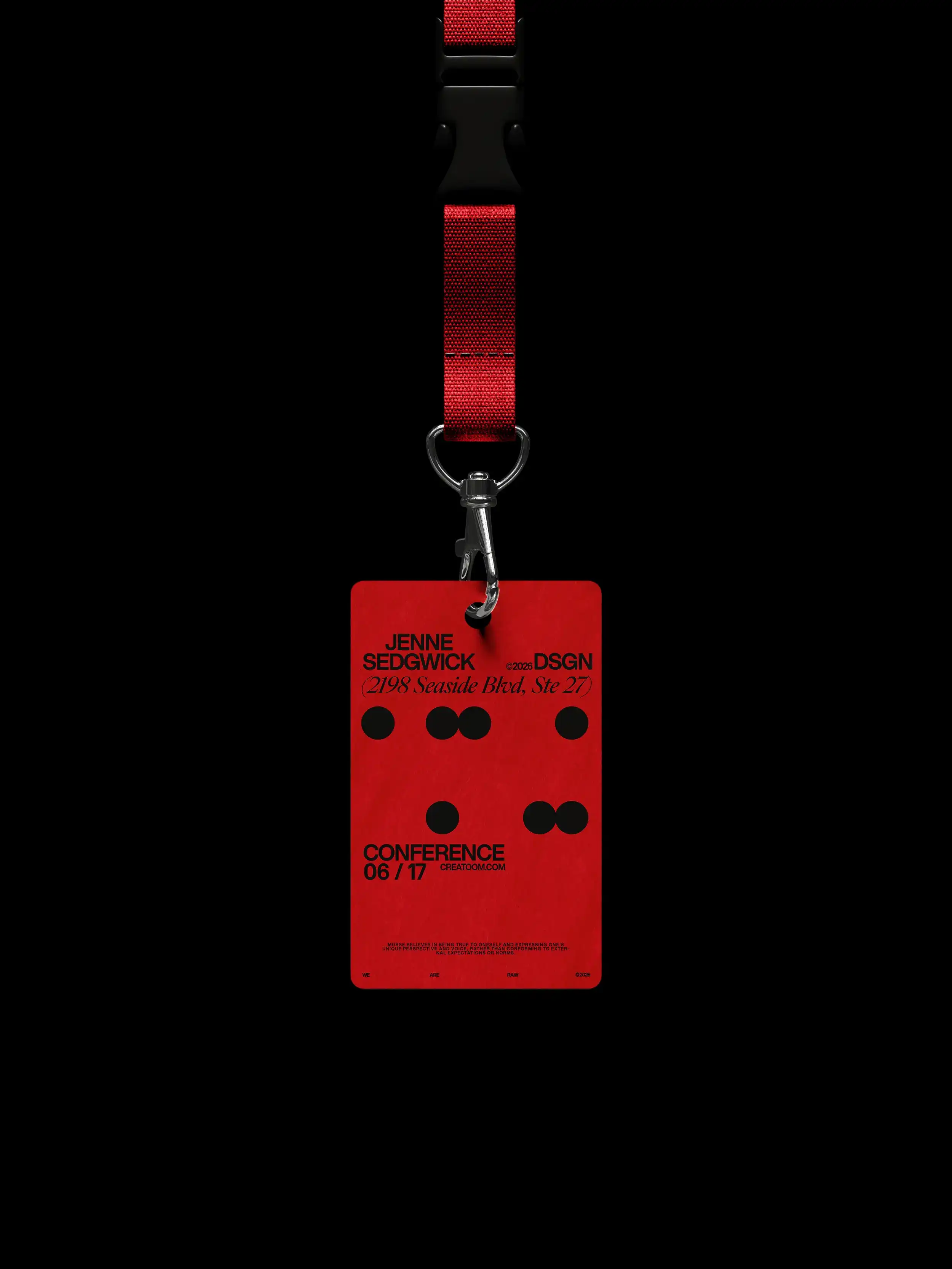 Red conference badge on lanyard against black background