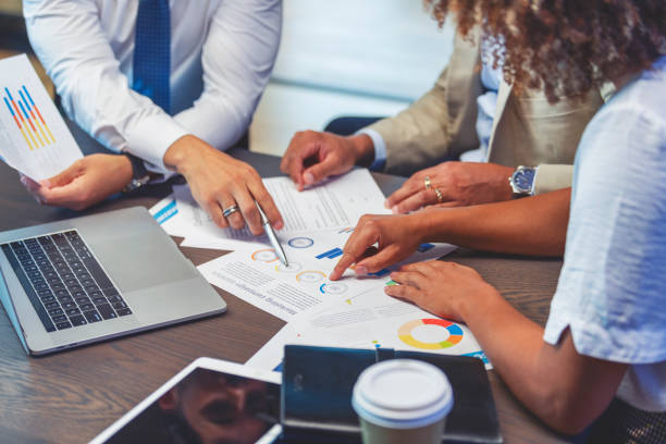 Picture of a trusted South Florida accounting sitting at a desk with their client to help them file taxes.