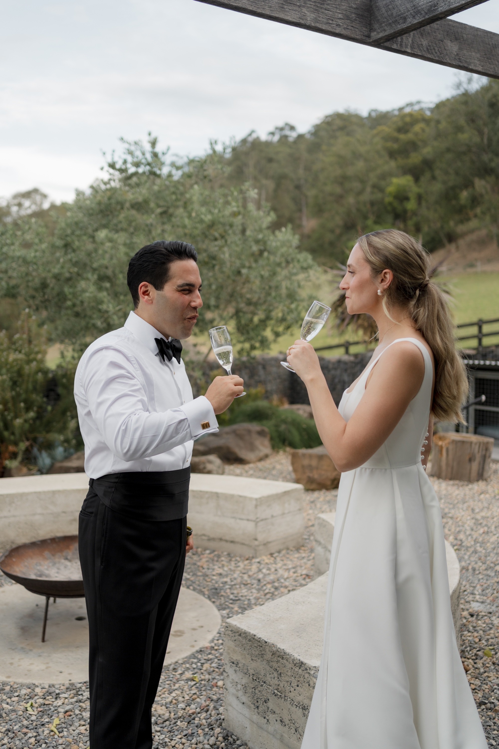 Newly married couple sharing champagne together during their reception