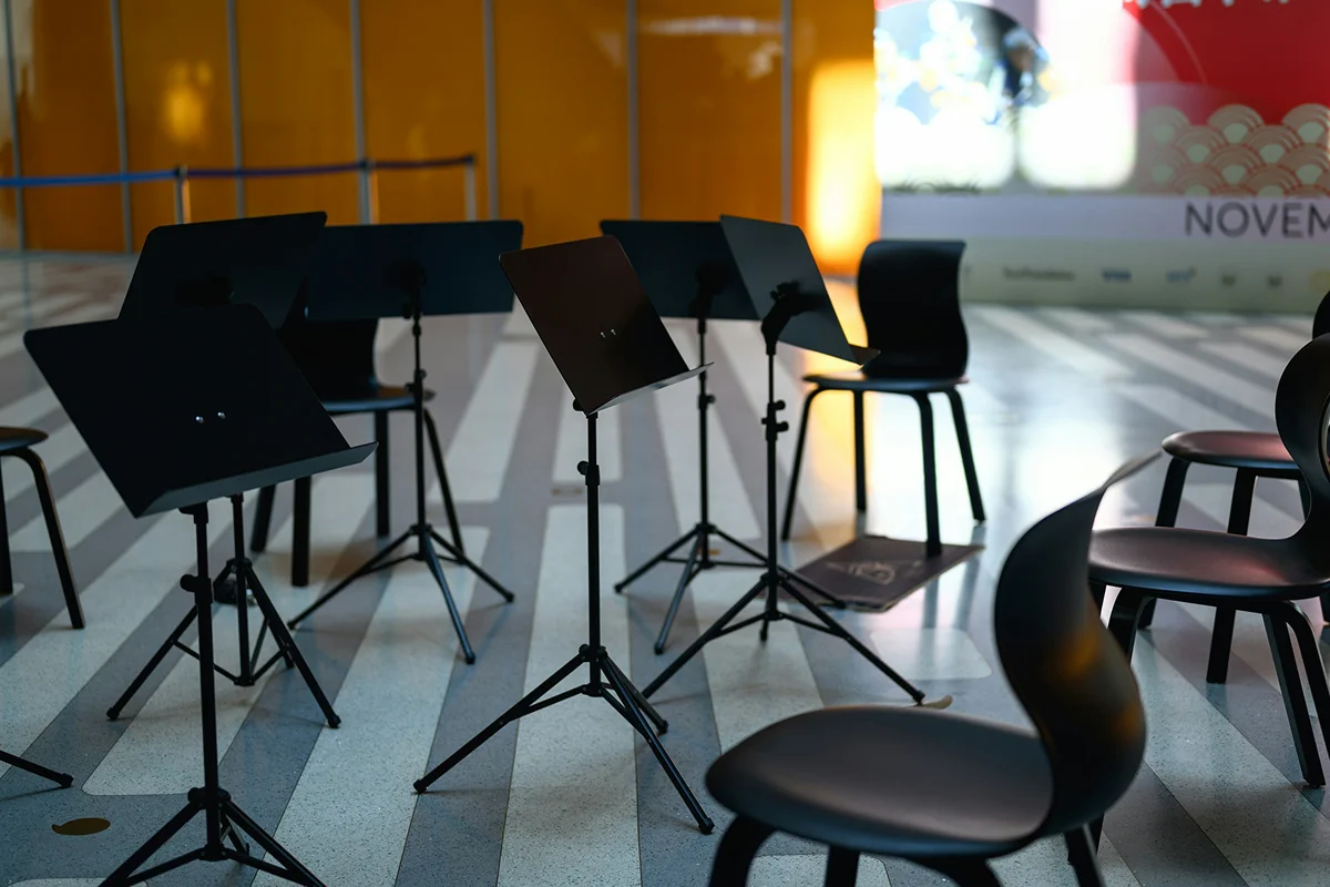 Teacher guiding students during music practice
