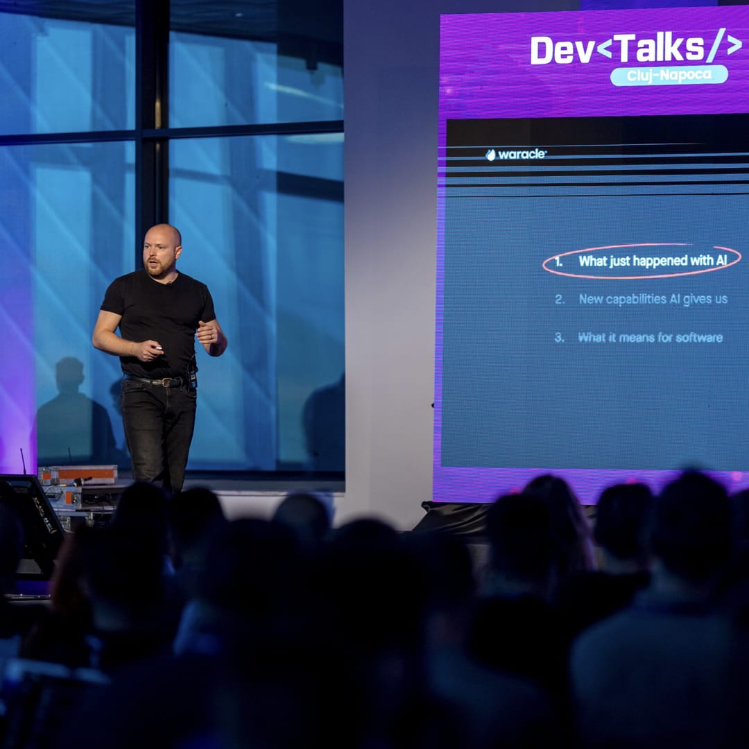 Gary Crawford presenting on stage at DevTalks Romania