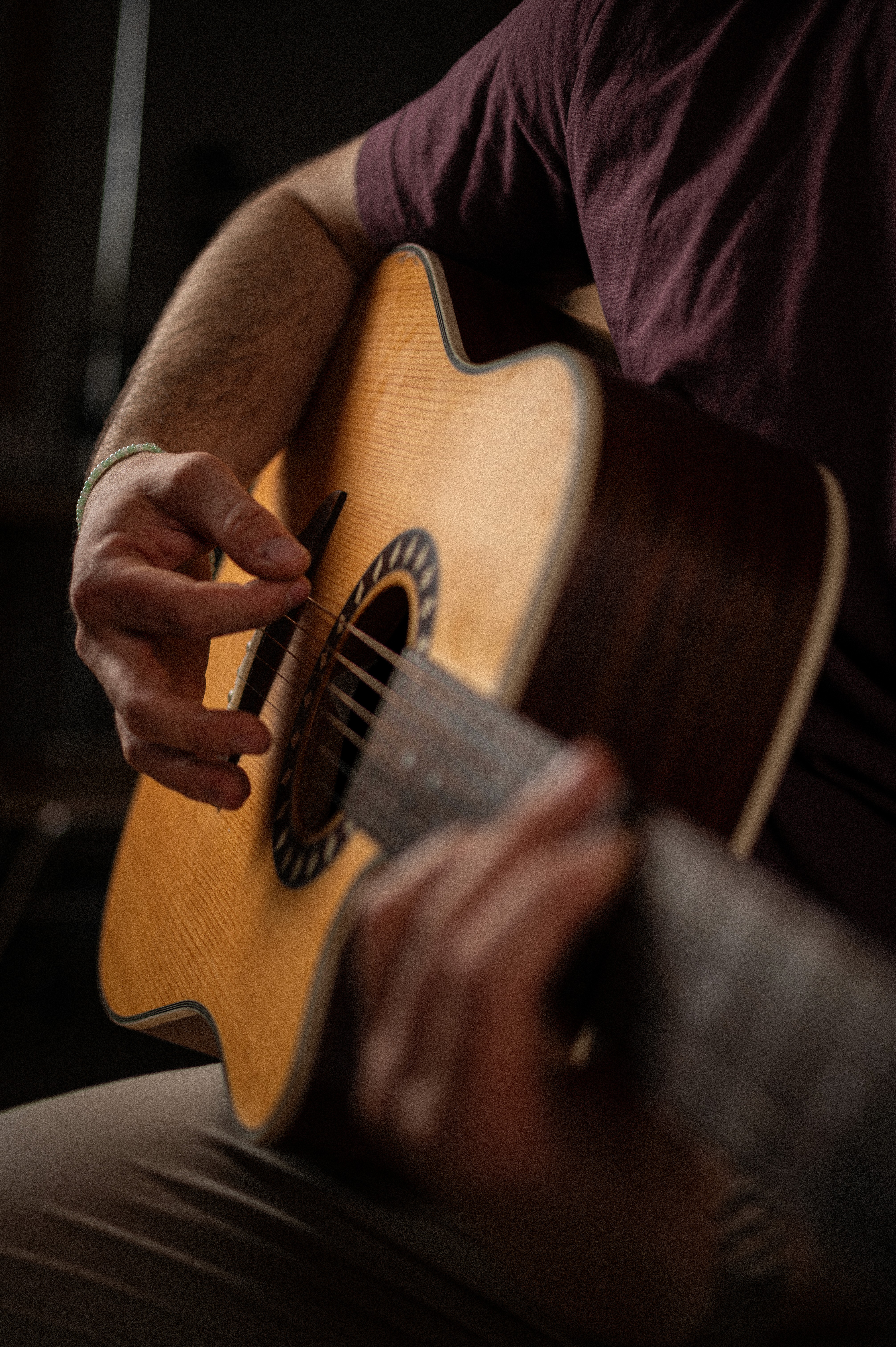 Der Musiker Lasse PTS steht frontal, trägt eine gelbe Mütze und hält eine Gitarre , während er in die Kamera blickt.