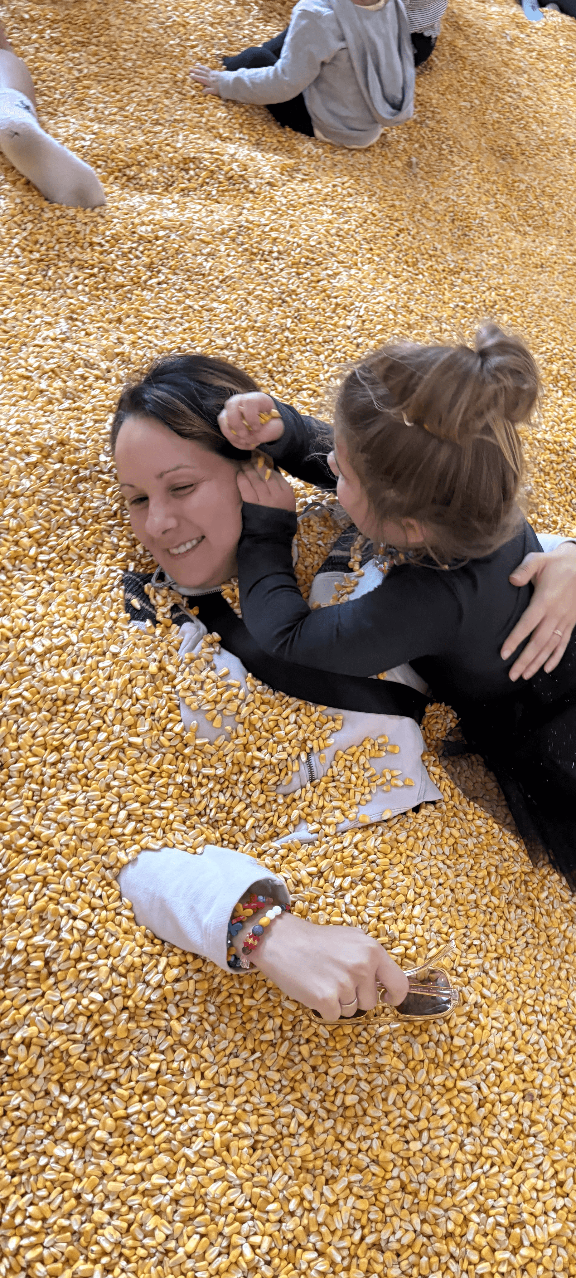 Portrait of a laughing person with curly hair wearing a white shirt