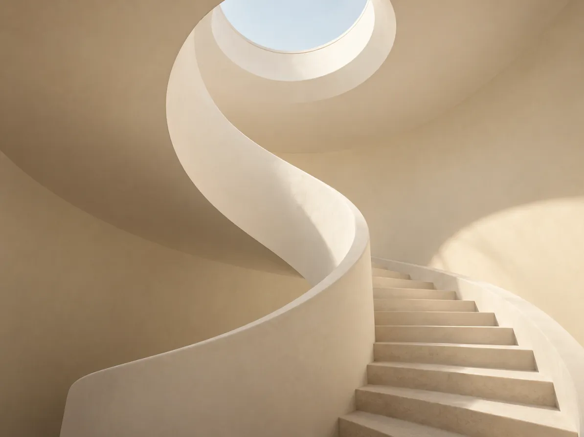 White spiral staircase winding toward a skylight