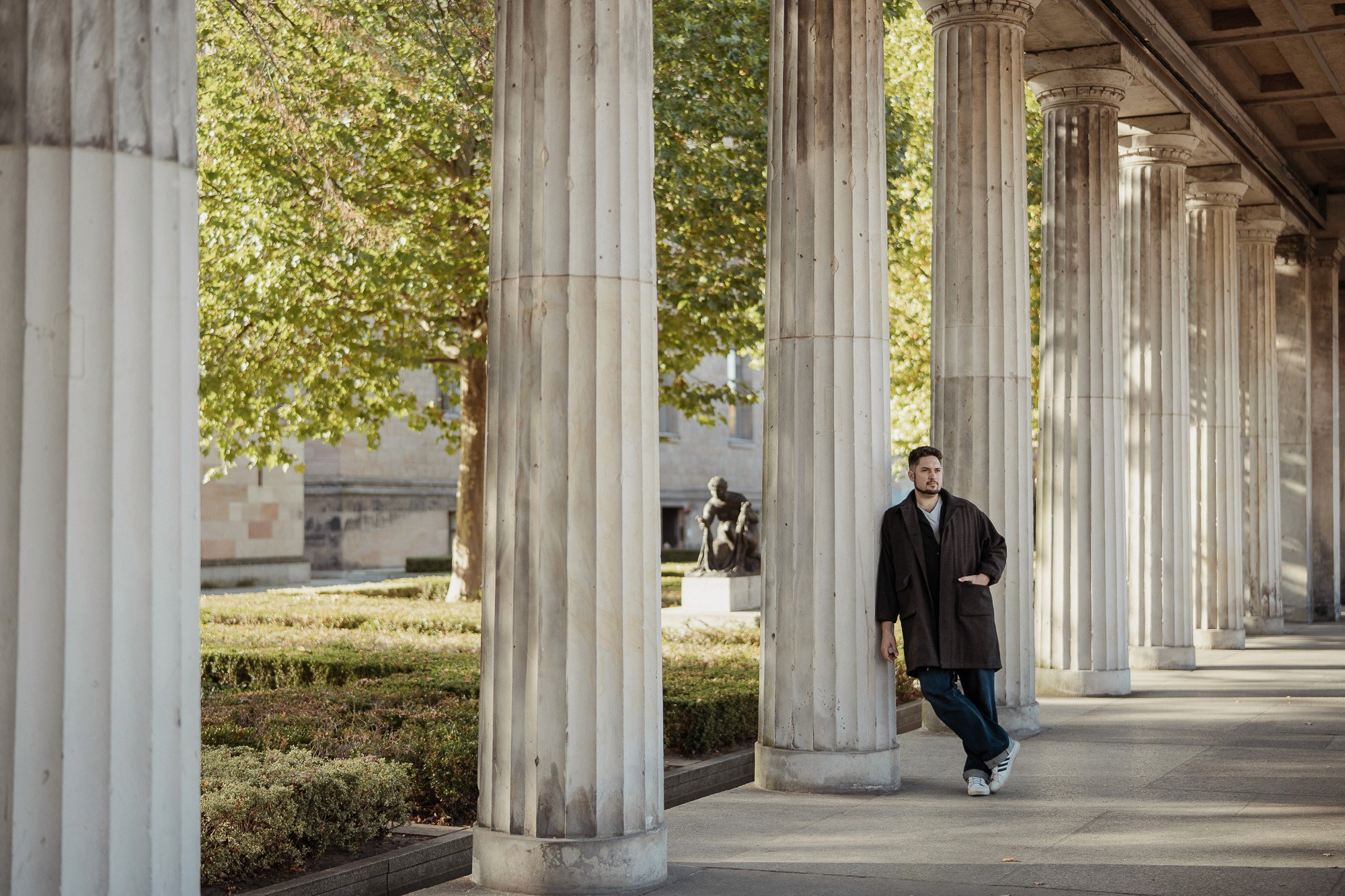 StoryOS founder standing among classical columns in Berlin, representing structure, clarity, and brand alignment
