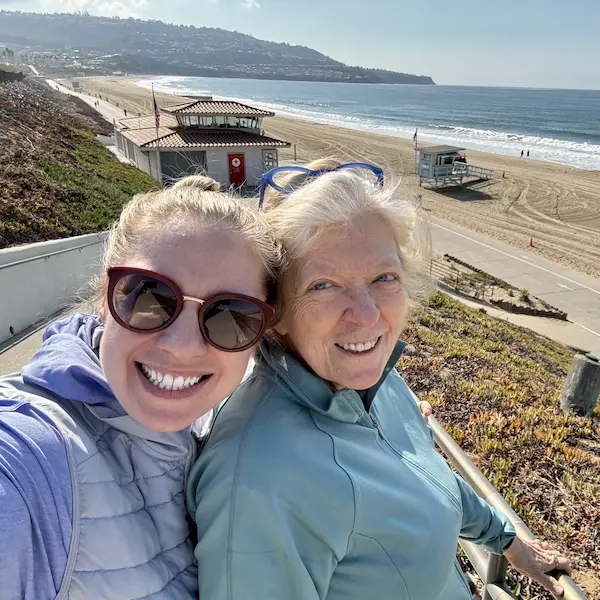 Carespondence founder and her mother smiling together at the beach