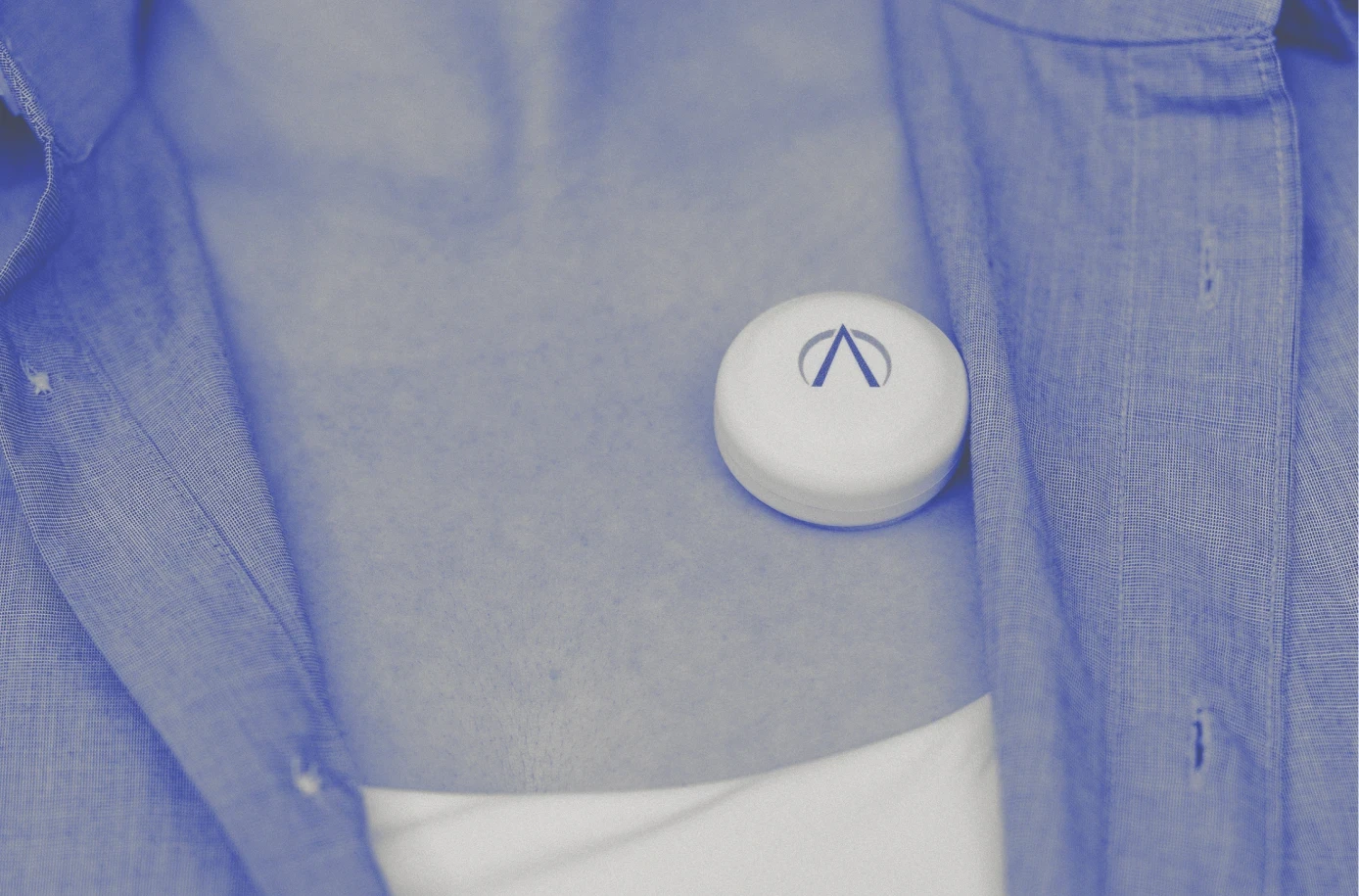 PneumoWave wearable respiratory monitoring sensor attached to patient chest, demonstrating connected health technology and remote monitoring.