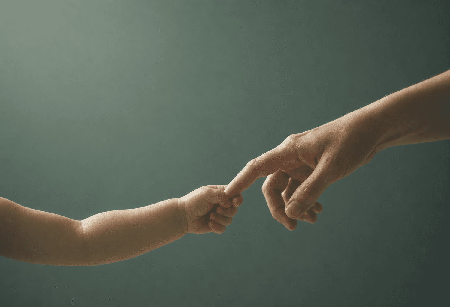 Boy sat on desk with arms folded
