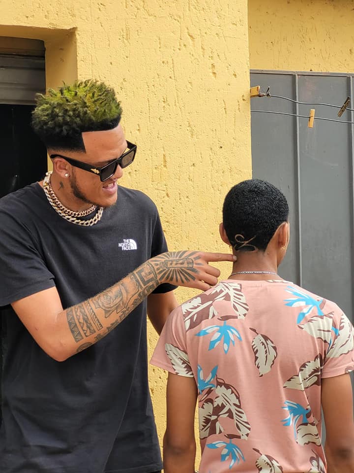 Ethan Collins with his customer post haircut showing the design he put at the back of his clients head