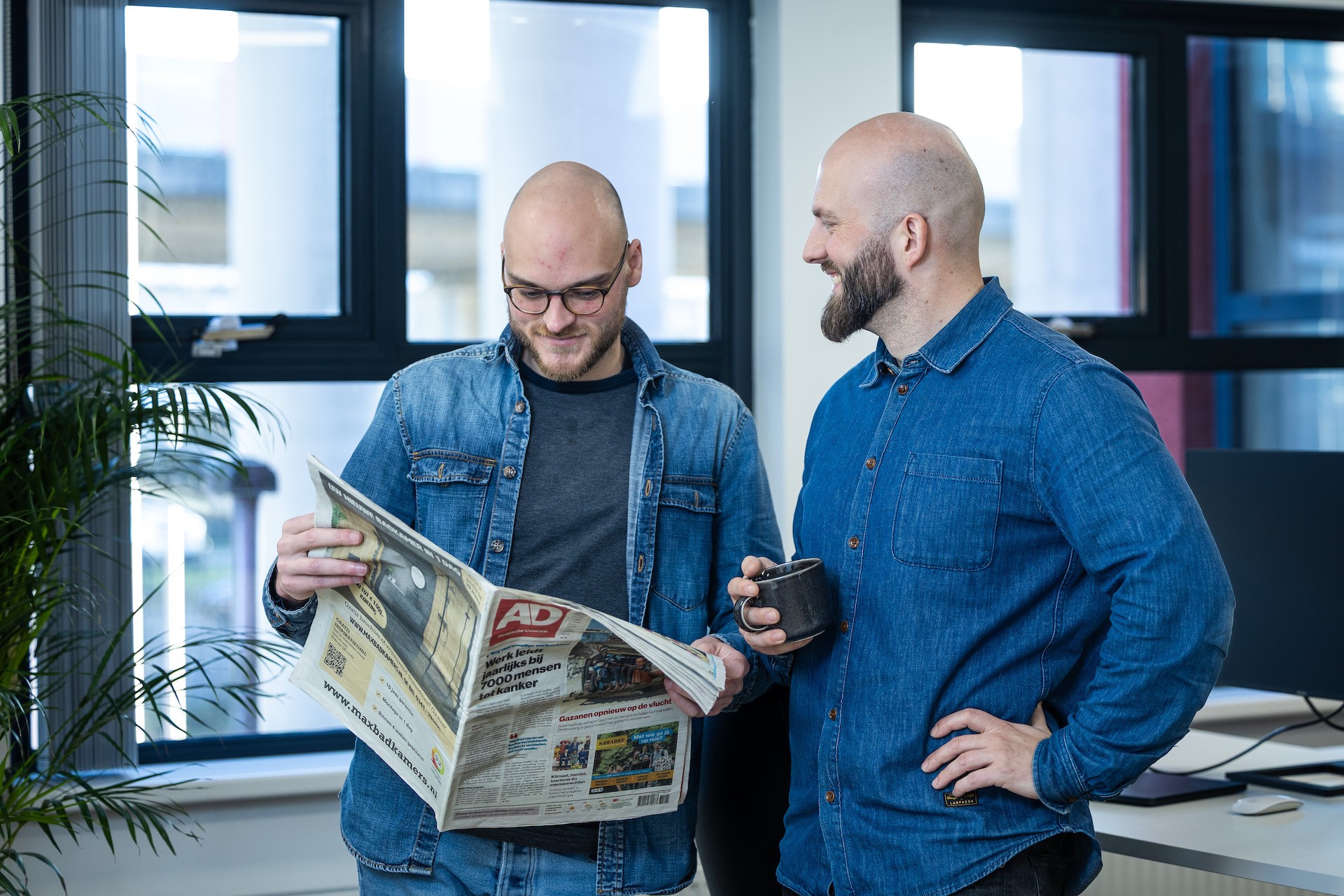 Founders of Blaudruck reading a newspaper