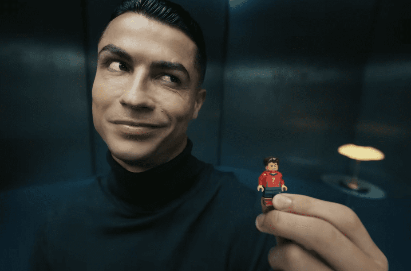 Cristiano ronaldo holding his lego miniature with world cup