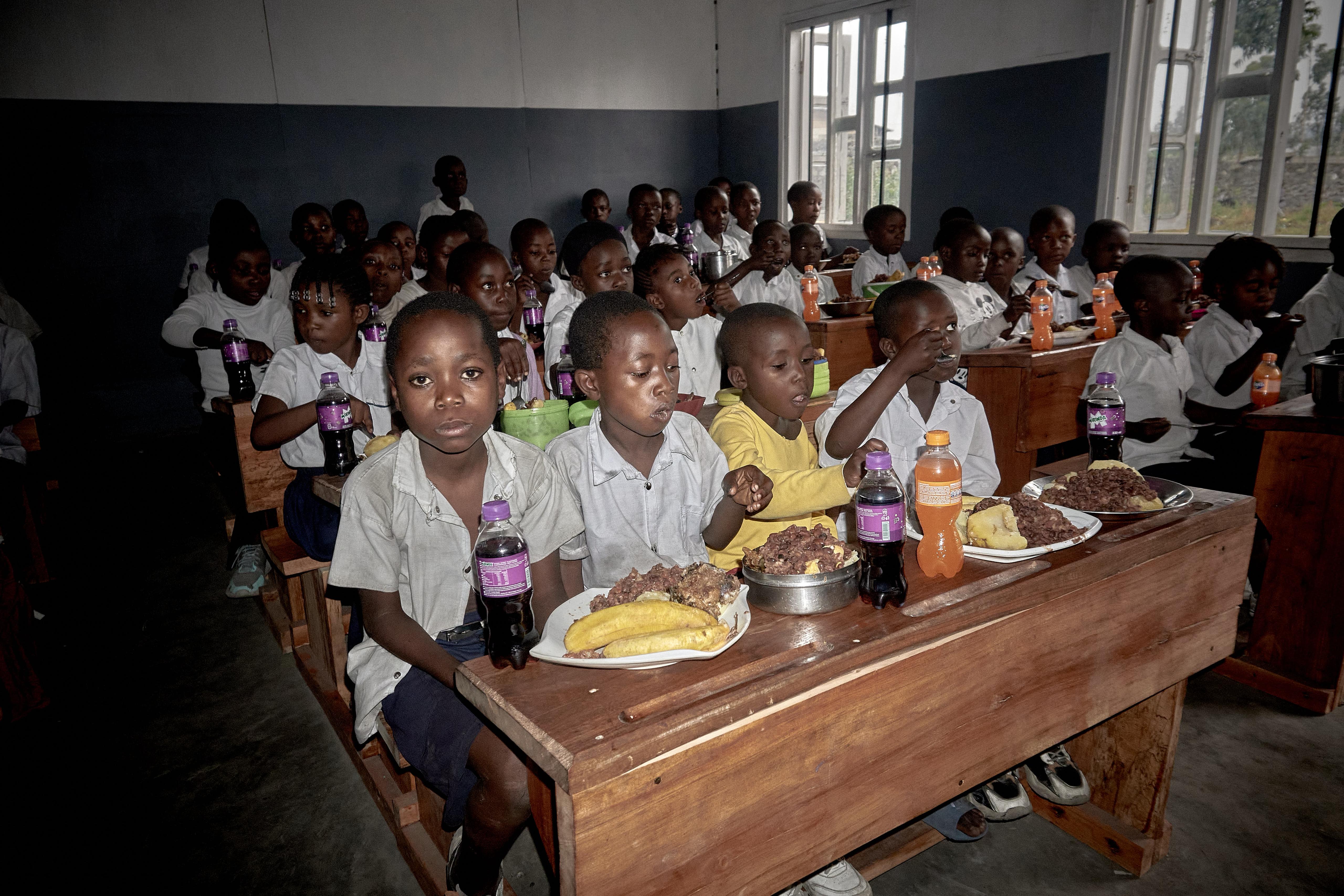 selective focus photography of woman standing surrounded by plants