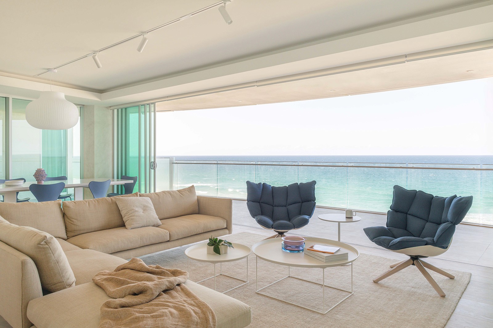 High Tide apartment living room with ocean-facing balcony, coastal furniture, and uninterrupted sea views in Surfers Paradise.