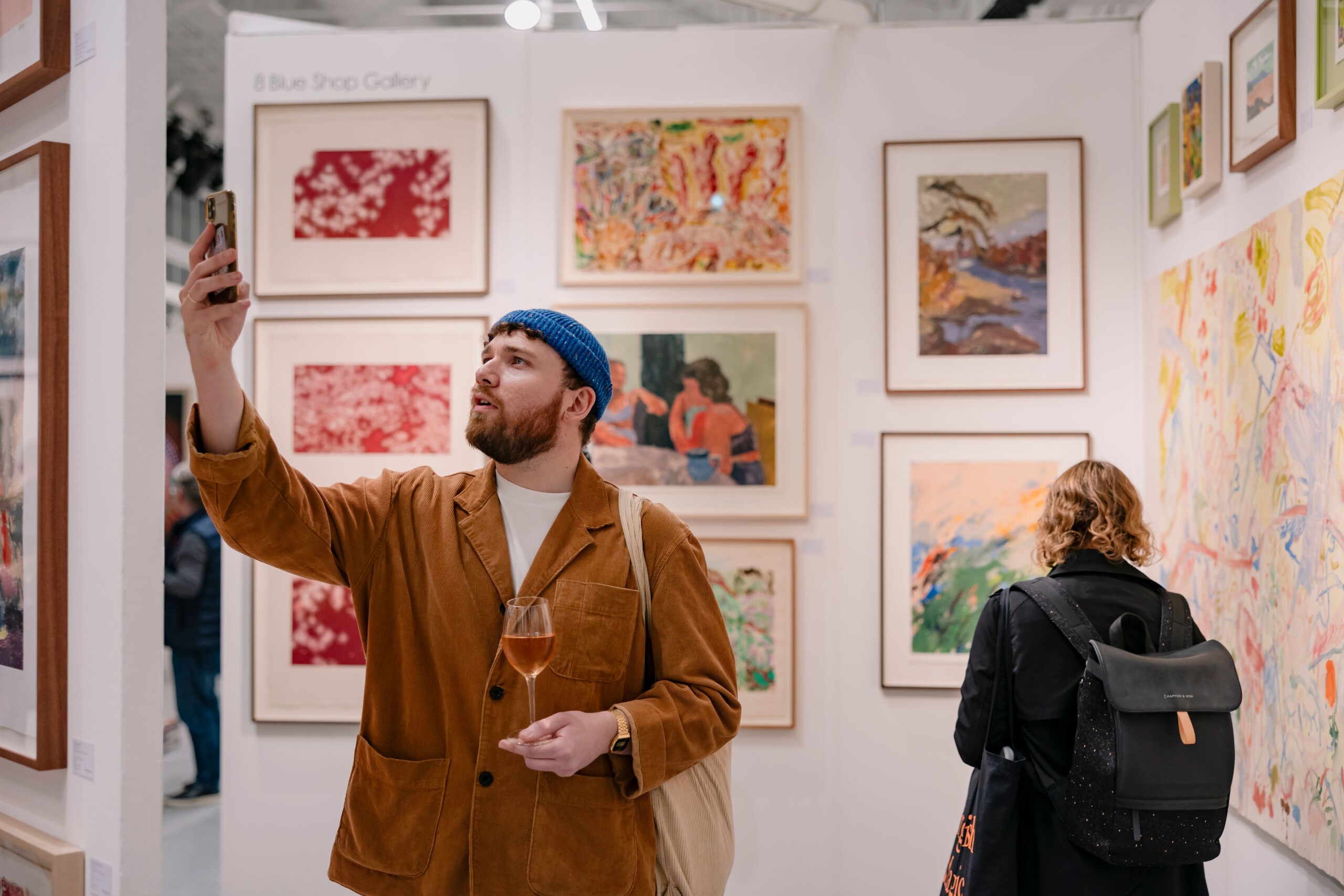 Black and white image of people working at a table with laptops, showing hands gesturing during discussion of digital content displayed on screens, with fabrica® logo in the corner.