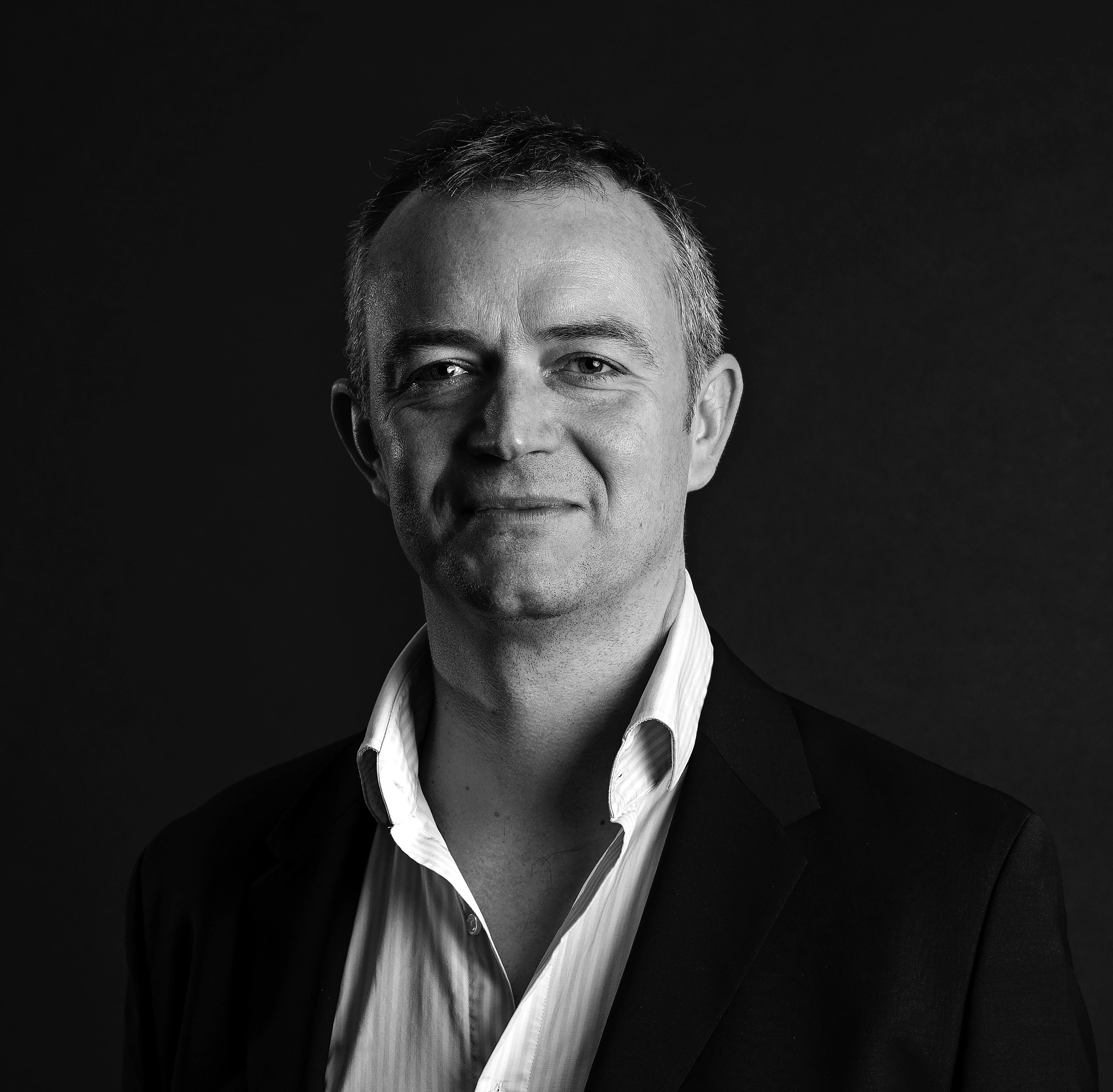 A professional headshot of a man