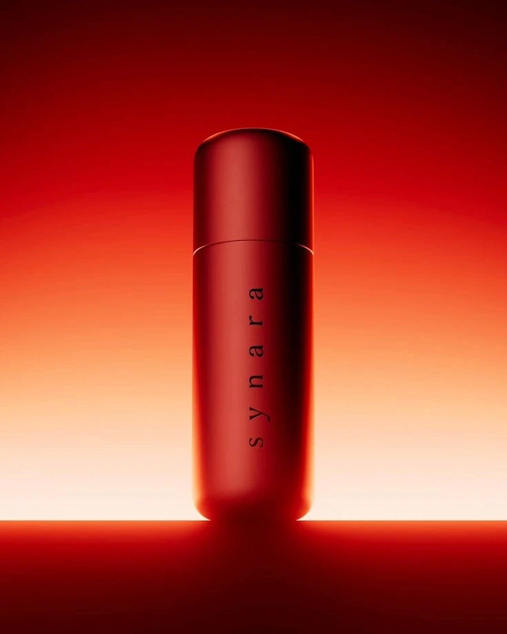 Product photo of a red Synara skincare bottle on a glowing red-orange backdrop