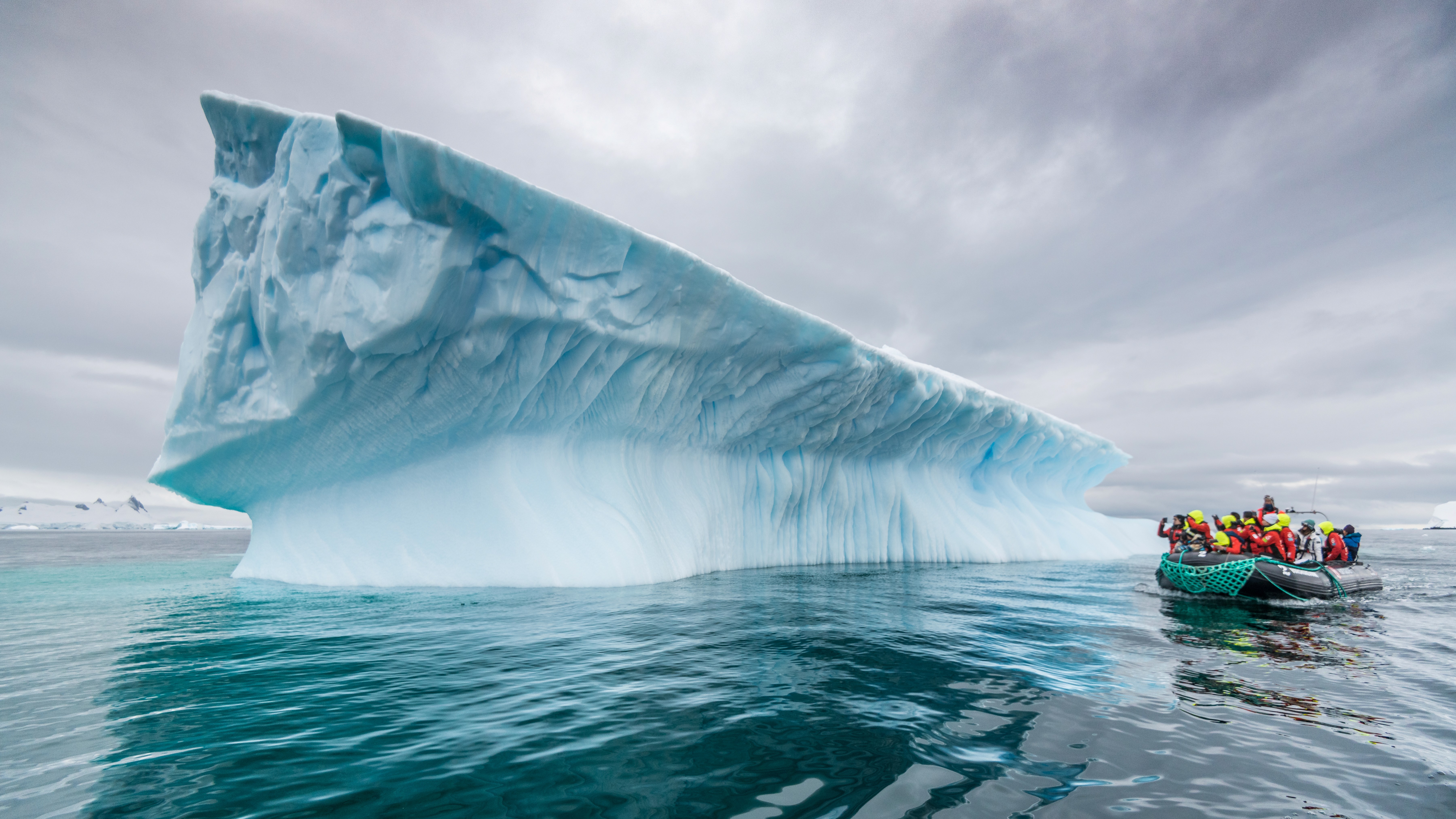 Guests on a zodiac admiring an iceberg in Antarctica