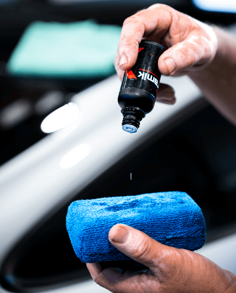 a man dropping ceramic coating onto a sponge