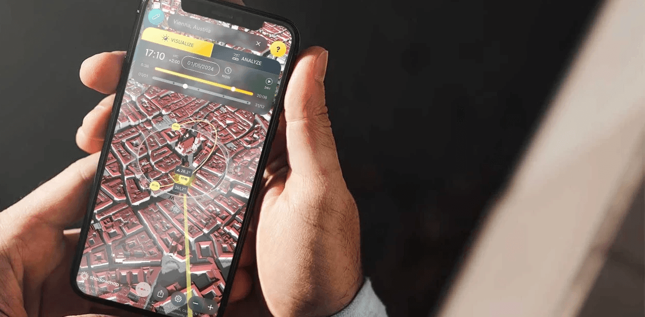 Shadowmap app on iPhone showing city of Vienna held by two hands