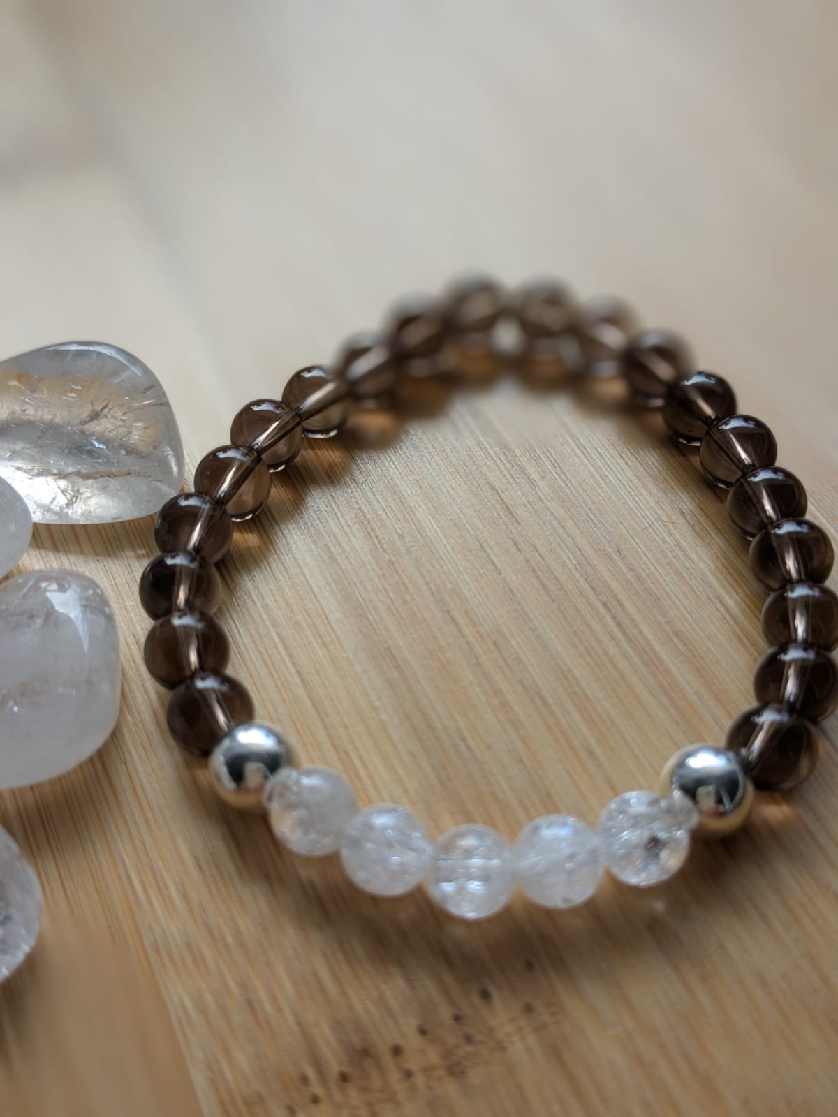 A woman lying on a massage bed, illuminated by soft sunlight streaming through a nearby window. A lush green plant in the background enhances the peaceful and rejuvenating ambiance.