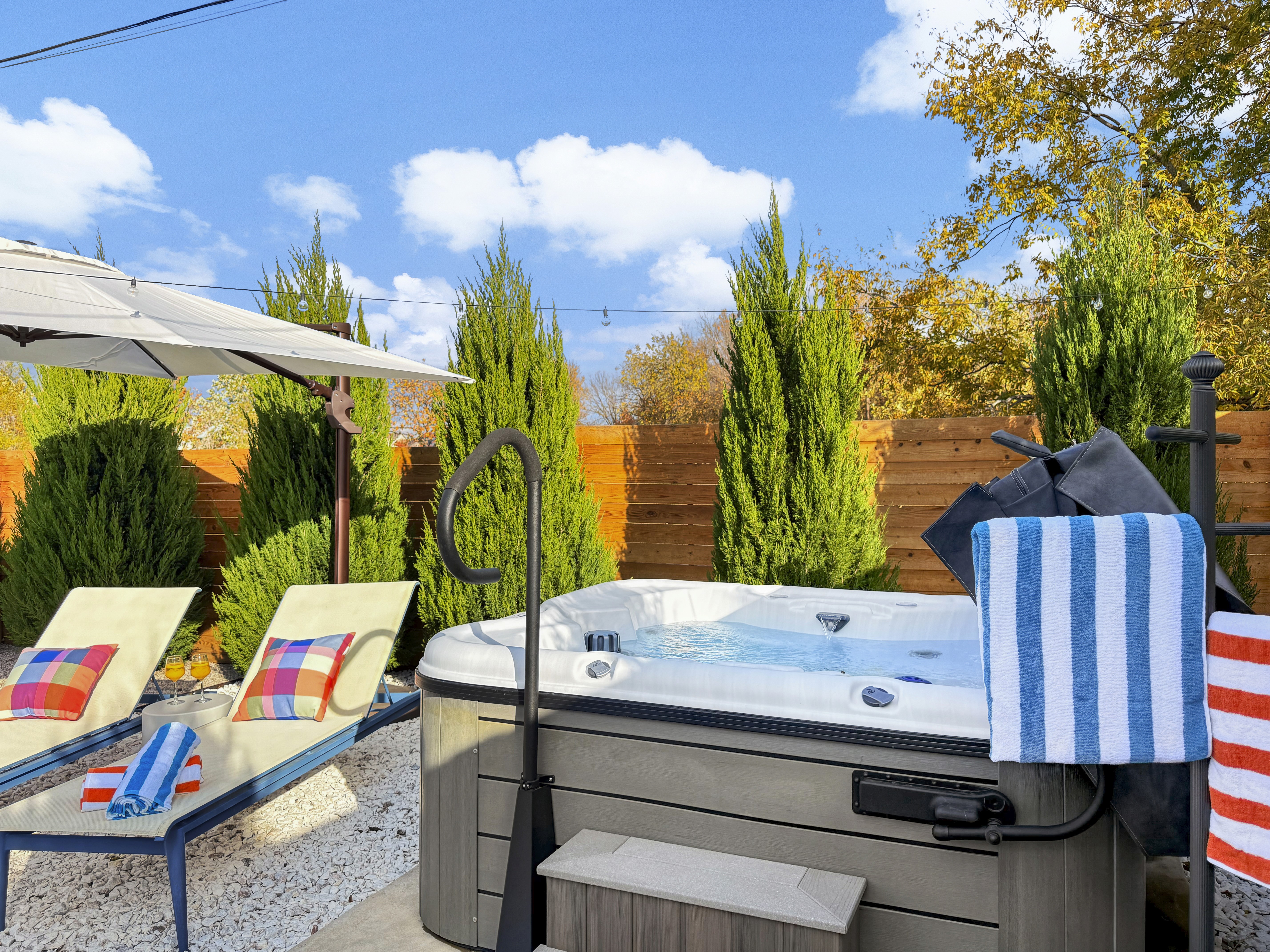 Relax in hot tub, sun lounders in private, fully landscaped backyard.