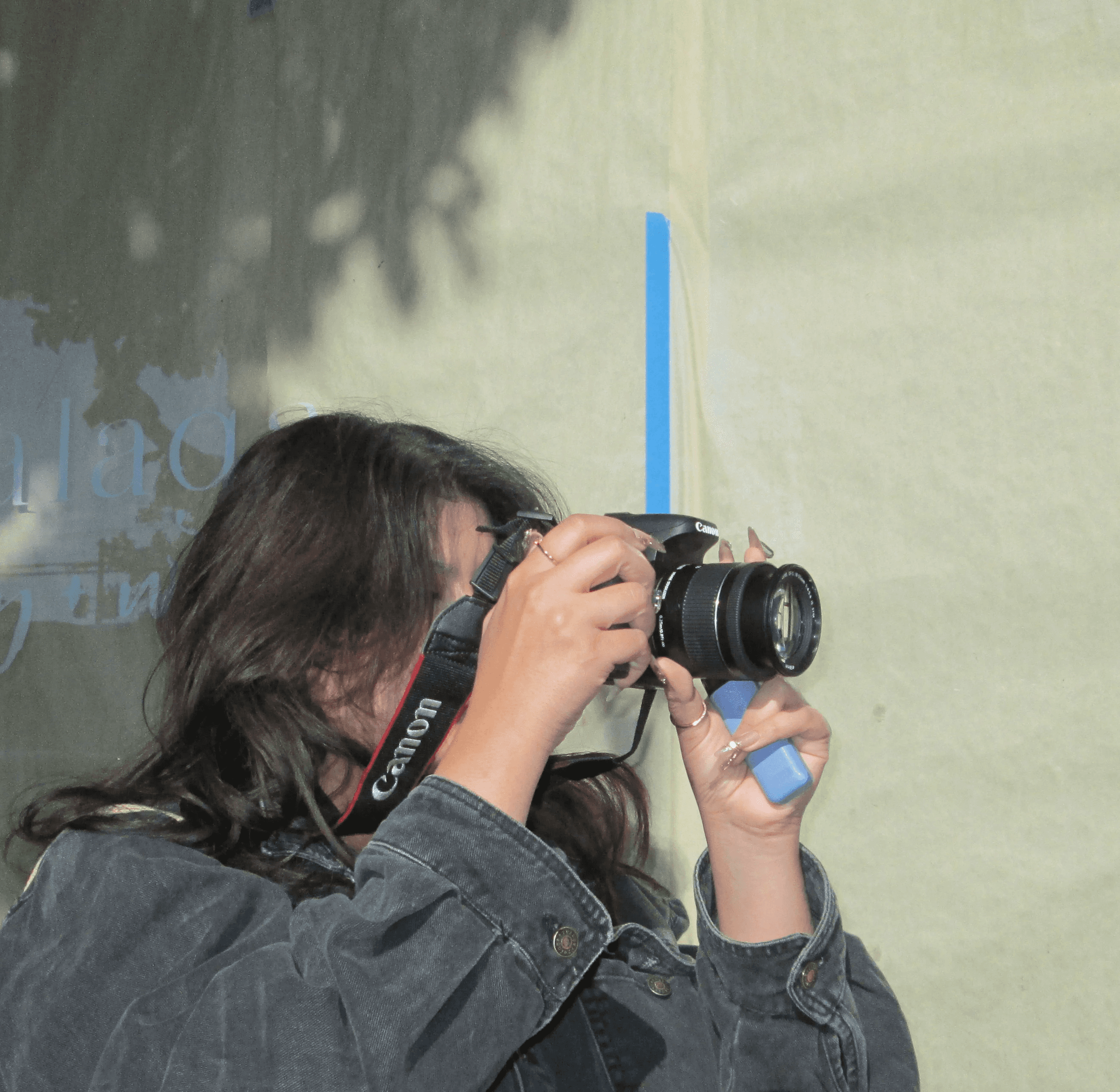 Close-up of a yellow tennis ball sitting on a green court, positioned near the white center line.