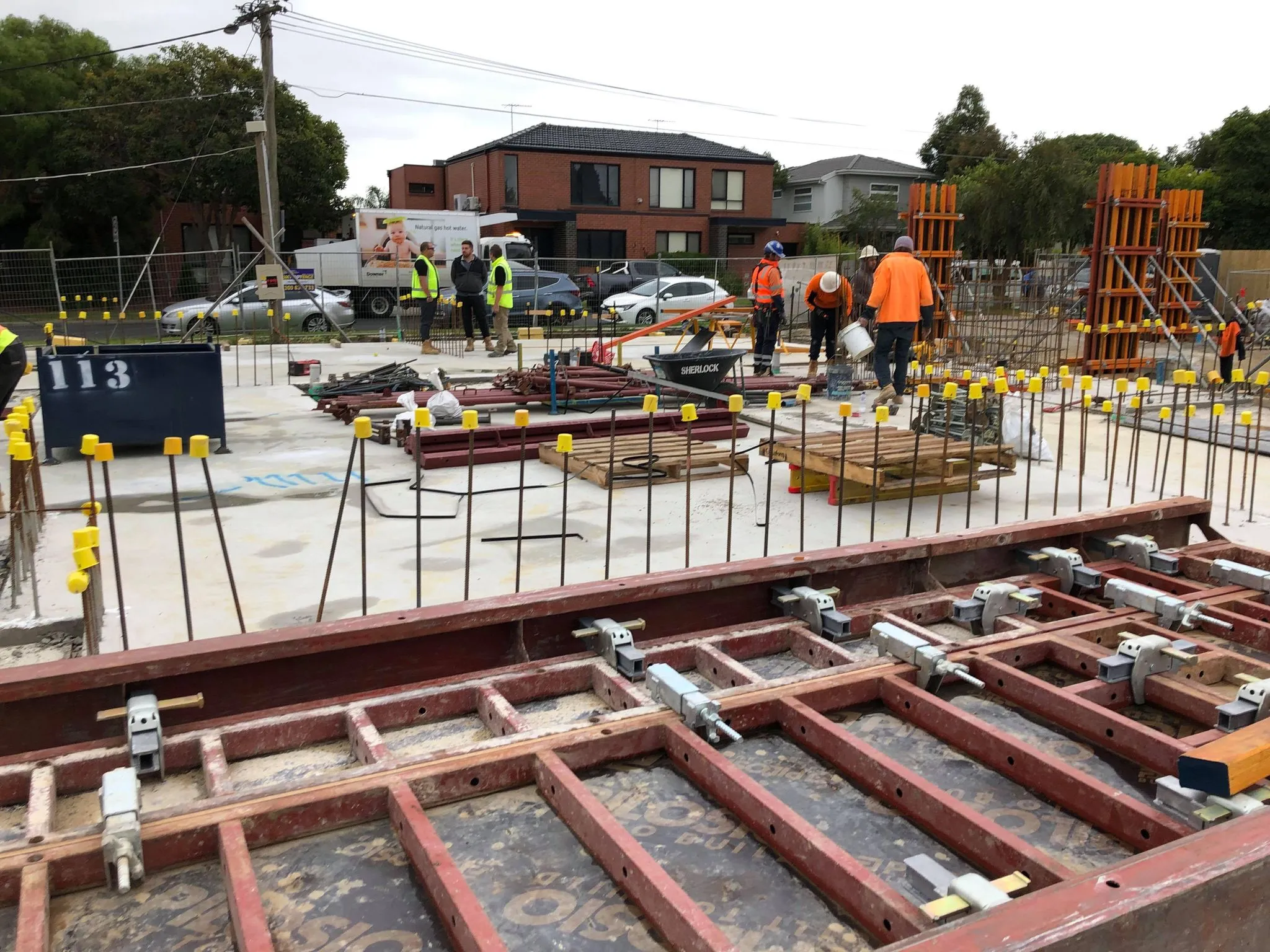 Image of construction workers at a residential building site at formwork stage by SubsQS Ltd