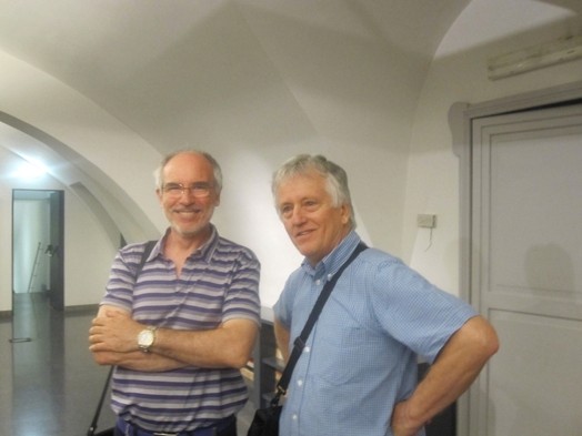 A photo of two people sitting in a hallway.