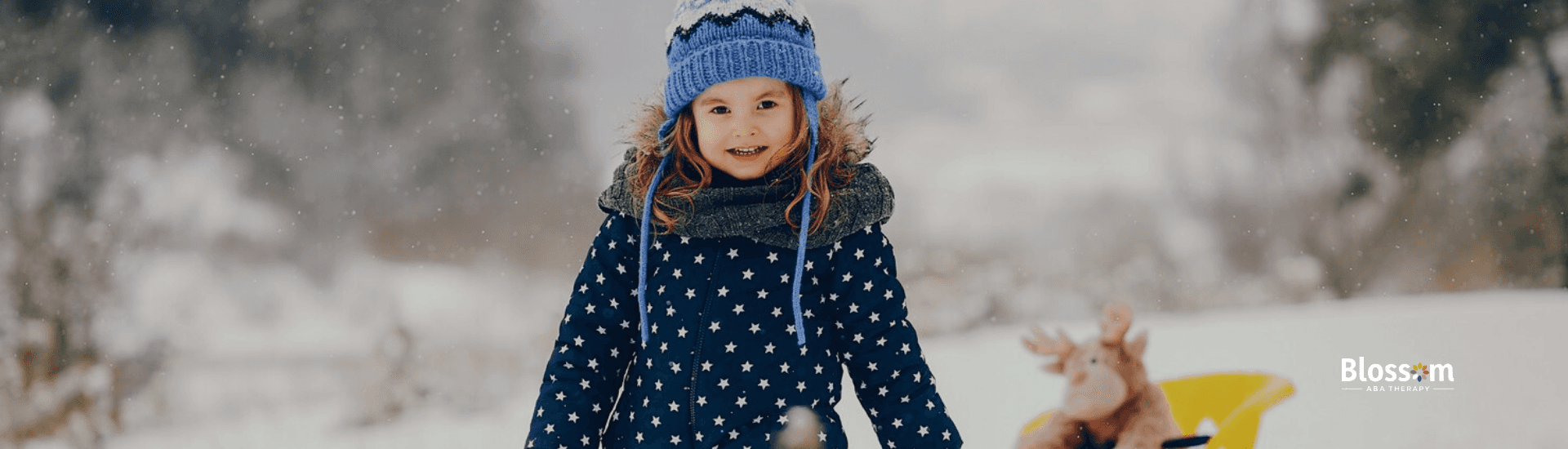 An autistic child playing in the snow